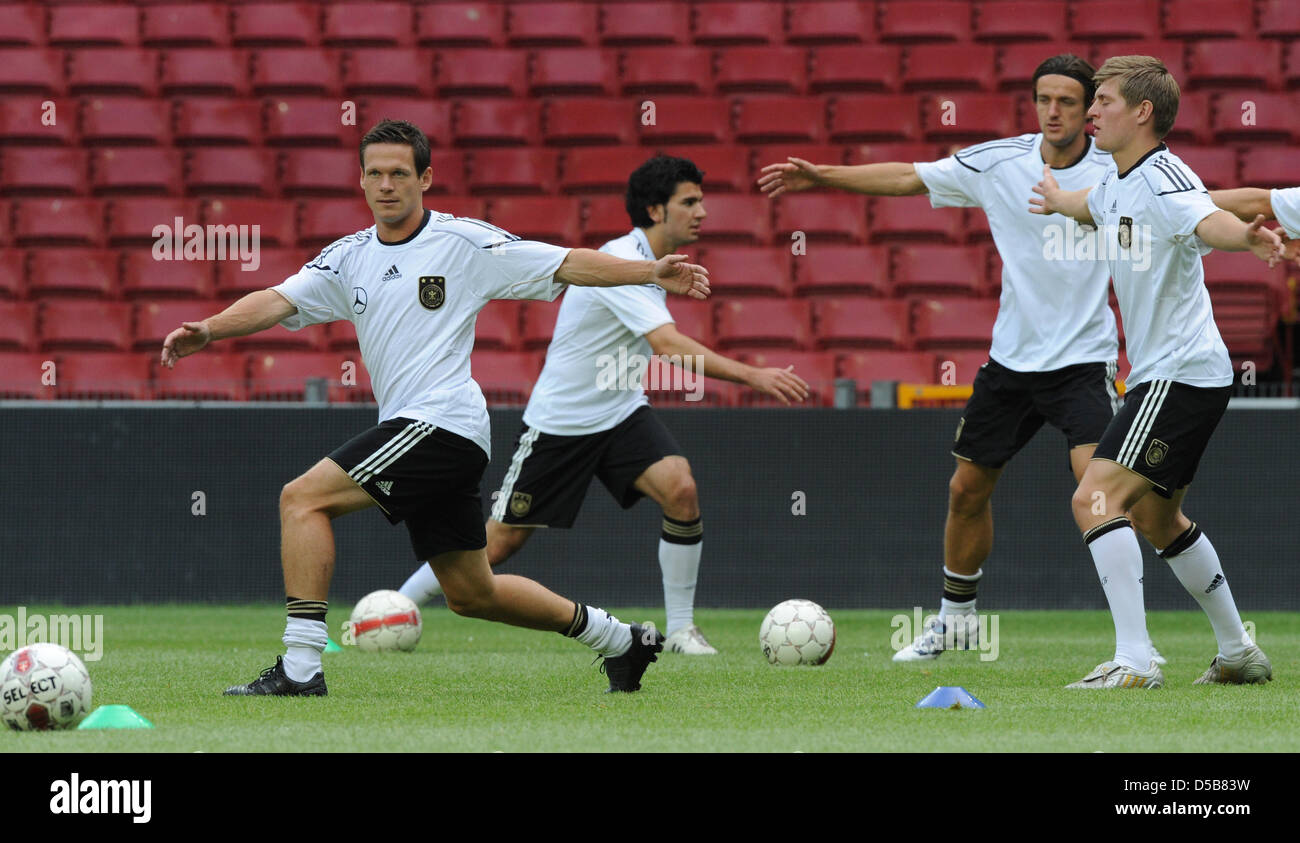 The players Sascha Riether (L-R), Serdar Tasci, Christian Gentner and Toni Kroos in action during a warm up session of a German national soccer team-training in the Parken Stadium in Copenhagen, Denmark, 10 August 2010. On Wednesday (11 August 2010), Germany plays a friendly game against Denmark. Photo: Marcus Brandt Stock Photo