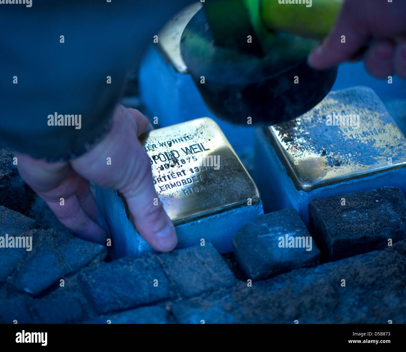 Berlin, Germany, laying stumbling blocks in Berlin-Charlottenburg Stock Photo