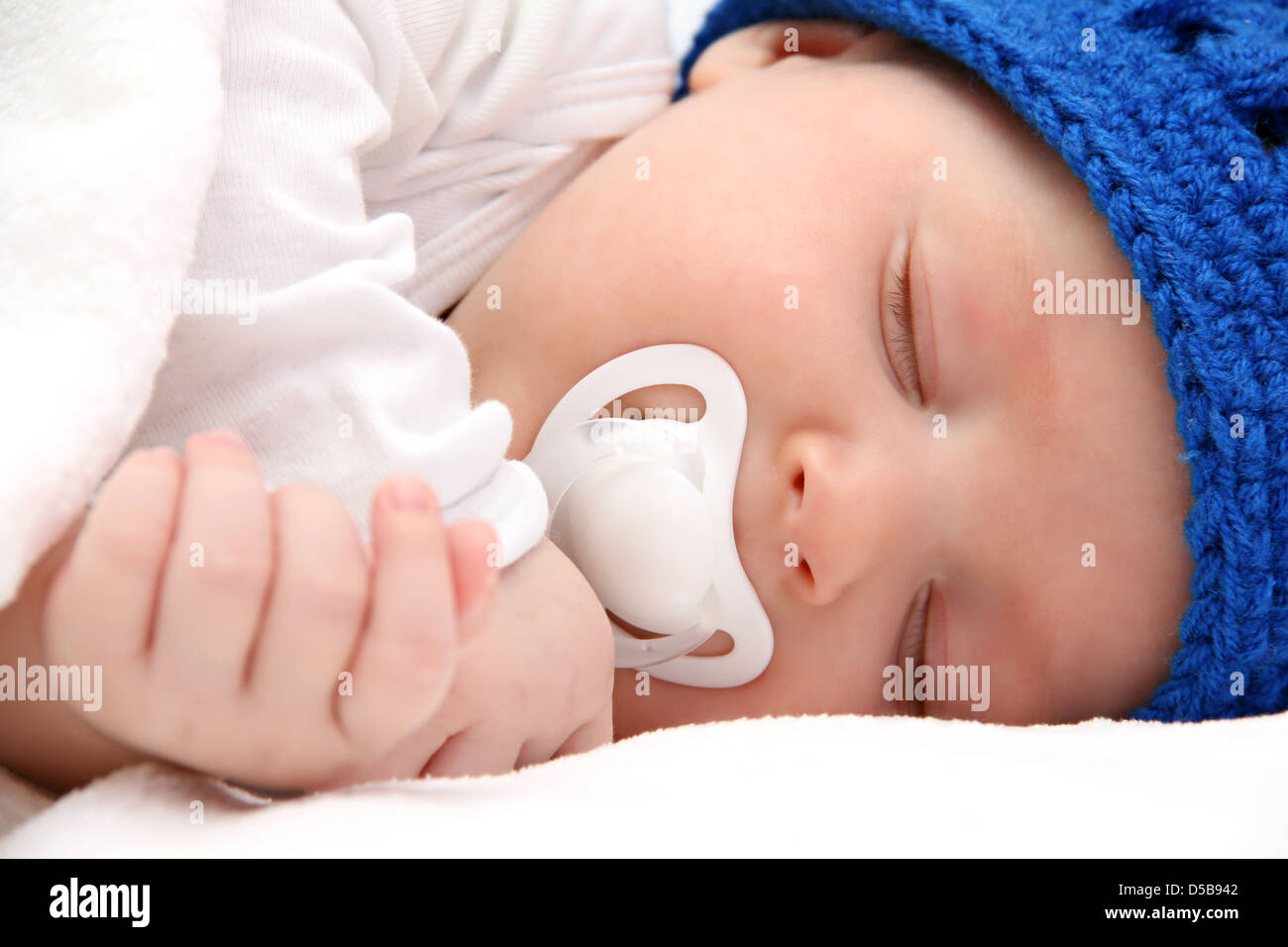 beautiful sleeping newborn baby with pacifier - closeup Stock Photo