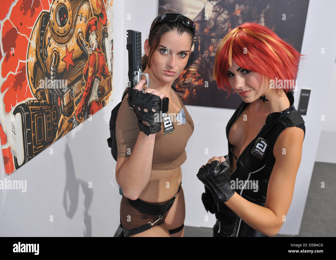 Dressed like action-heroes, hostesses of the booth 'The Art of Games' pose during the fair 'Gamescom' in Cologne, Germany, 18 August 2010. The computer game-fair 'Gamescom' takes place between the 18 August and the 22 August 2010 in Cologne. Photo: Jörg Carstensen Stock Photo