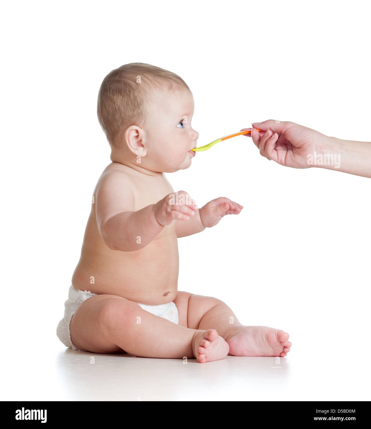 Little baby feeding with a spoon Stock Photo - Alamy