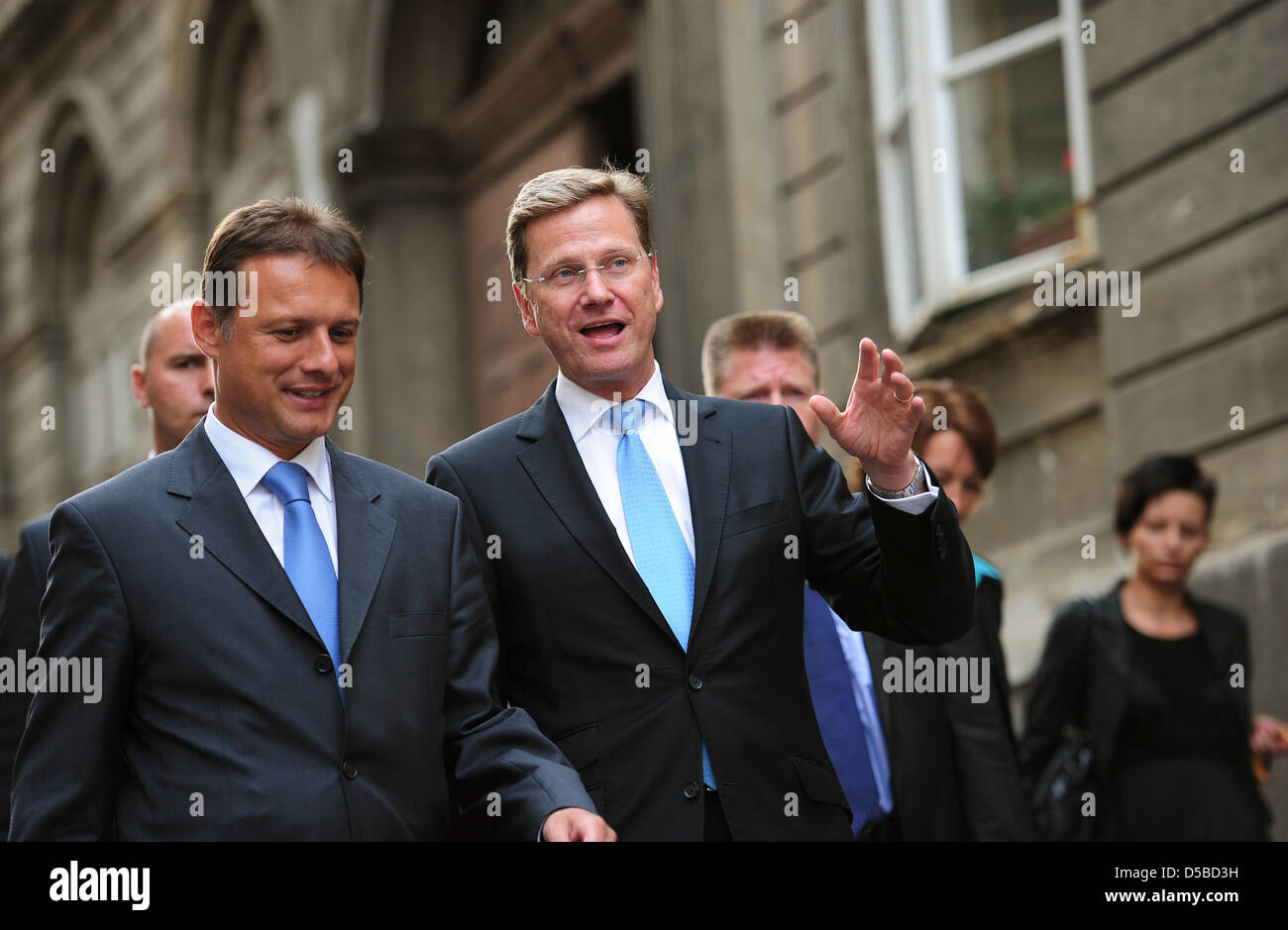 The Croatian Foreign Minister Gordan Jandrokovic (L) and German Foreign Minister Guido Westerwelle talk during a walk through the old city centre of Zagreb, Croatia, 25 August 2010. Westerwelle visits the Balkan states during a three-day trip. PHOTO: HANNIBAL HANSCHKE Stock Photo