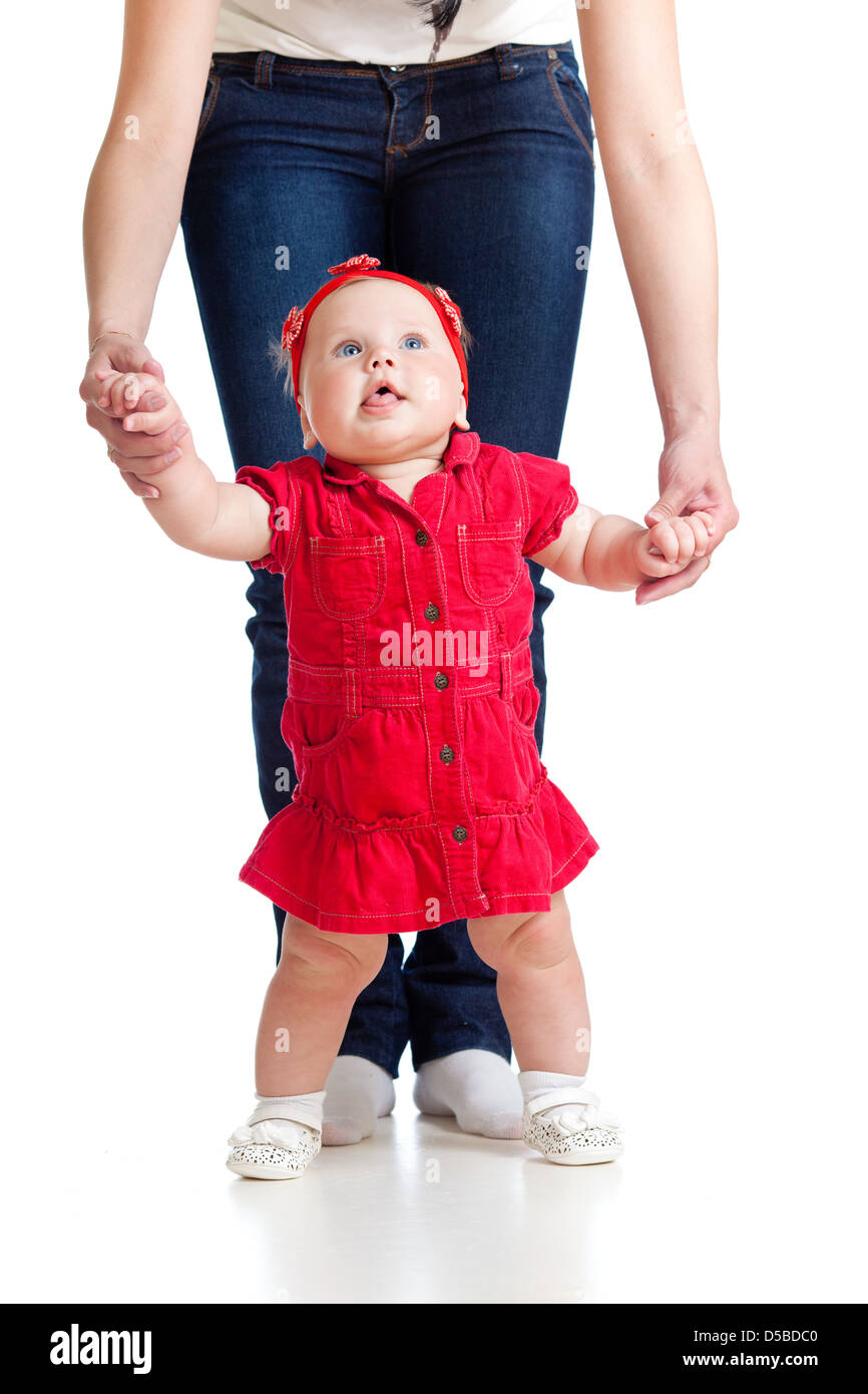 little baby girl doing first step with help of mother Stock Photo - Alamy