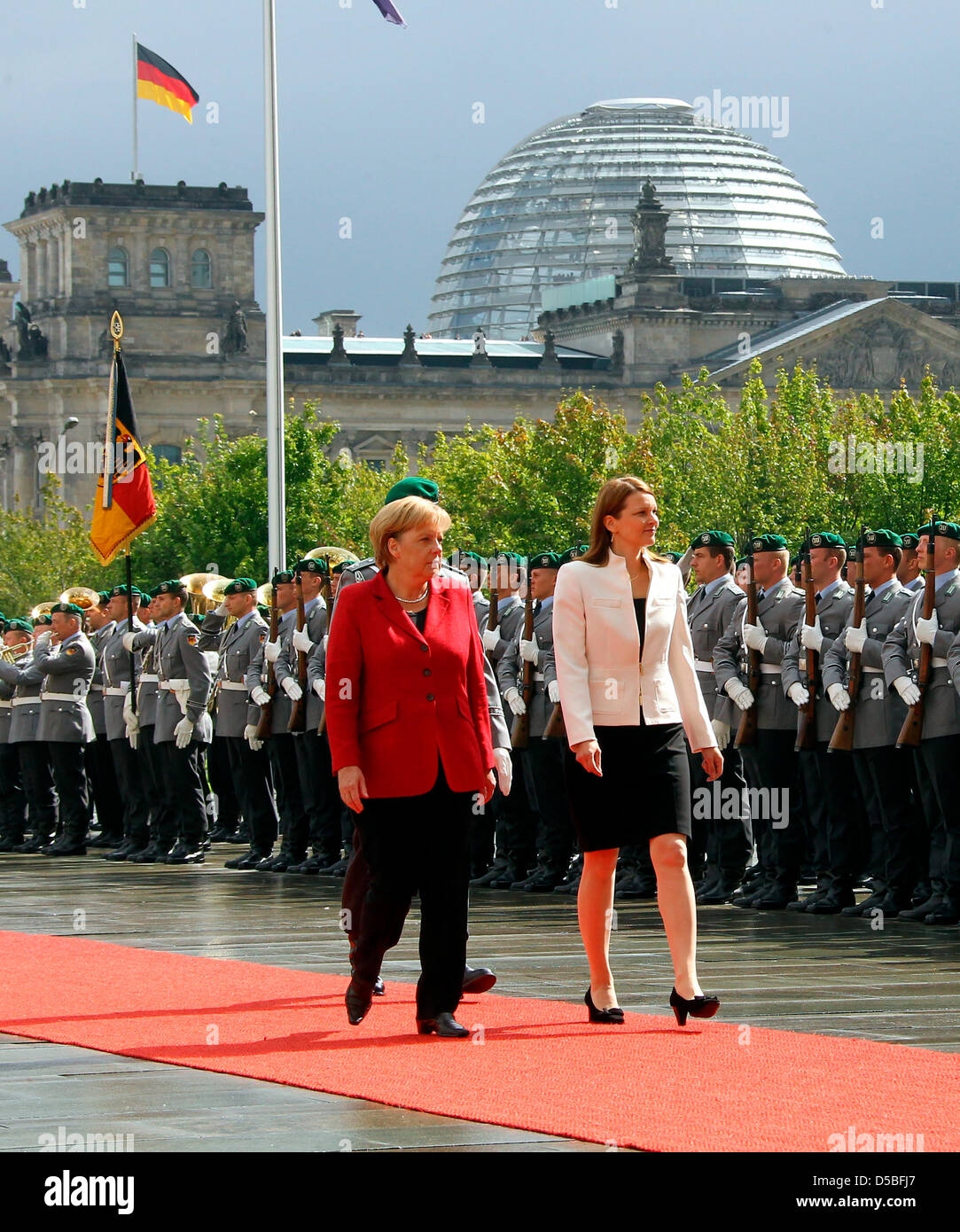 German Chancellor Angela Merkel (L) receives Finnish Prime Minister Mari Johanna Kiviniemi in front of the Chancellery in Berlin, Germany, 01 September 2010. The Reichstag looms in the background. Photo: Wolfgang Kumm Stock Photo
