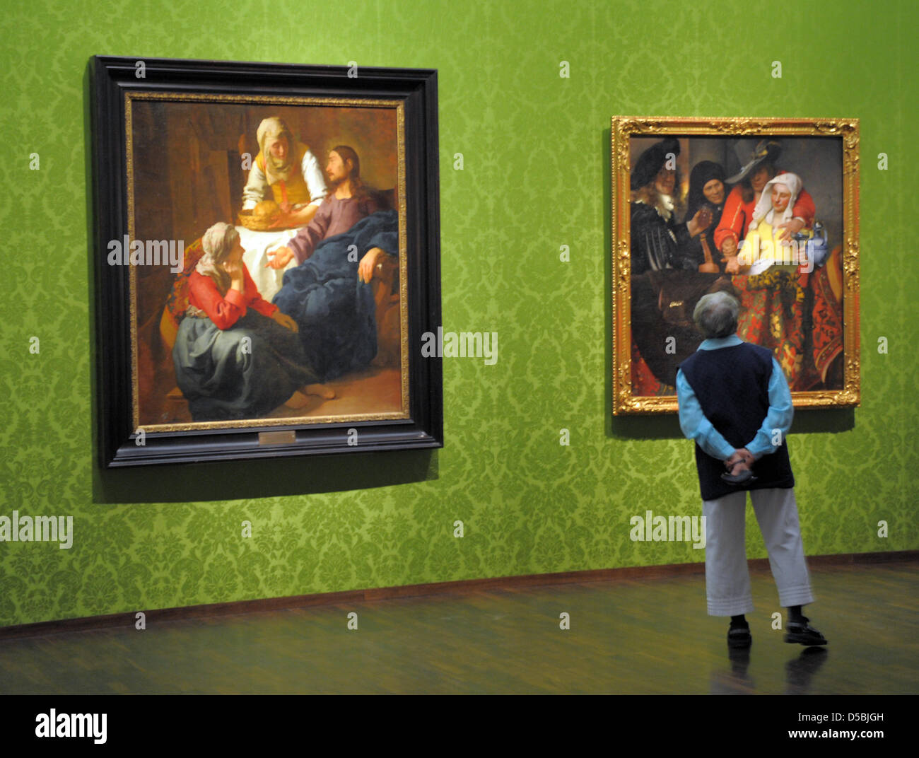 Visitors observe the paintings 'Christ in the House of Martha and Mary' of 1655 and 'The Procuress' of 1656 in the Old Masters Picture Gallery in Dresden, Germany, 03 September 2010. The special exhibition 'The early Vermeer' takes place until 28 November 2010. Photo: Matthias Hiekel Stock Photo