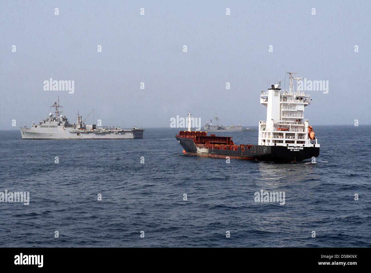 A William Farmerie/US Navy handout picture features the U.S. Navy amphibious transport dock ship 'USS Dubuque (LPD 8)' (C), with the Turkish frigate TCG Gokceada during a board and seizure operation by the U.S. Marine Corps 15th Marine Expeditionary Unit, Maritime Raid Force, embarked aboard Dubuque in the Gulf of Aden, 9 September, 2010. The German motor vessel M/V Magellan Star w Stock Photo