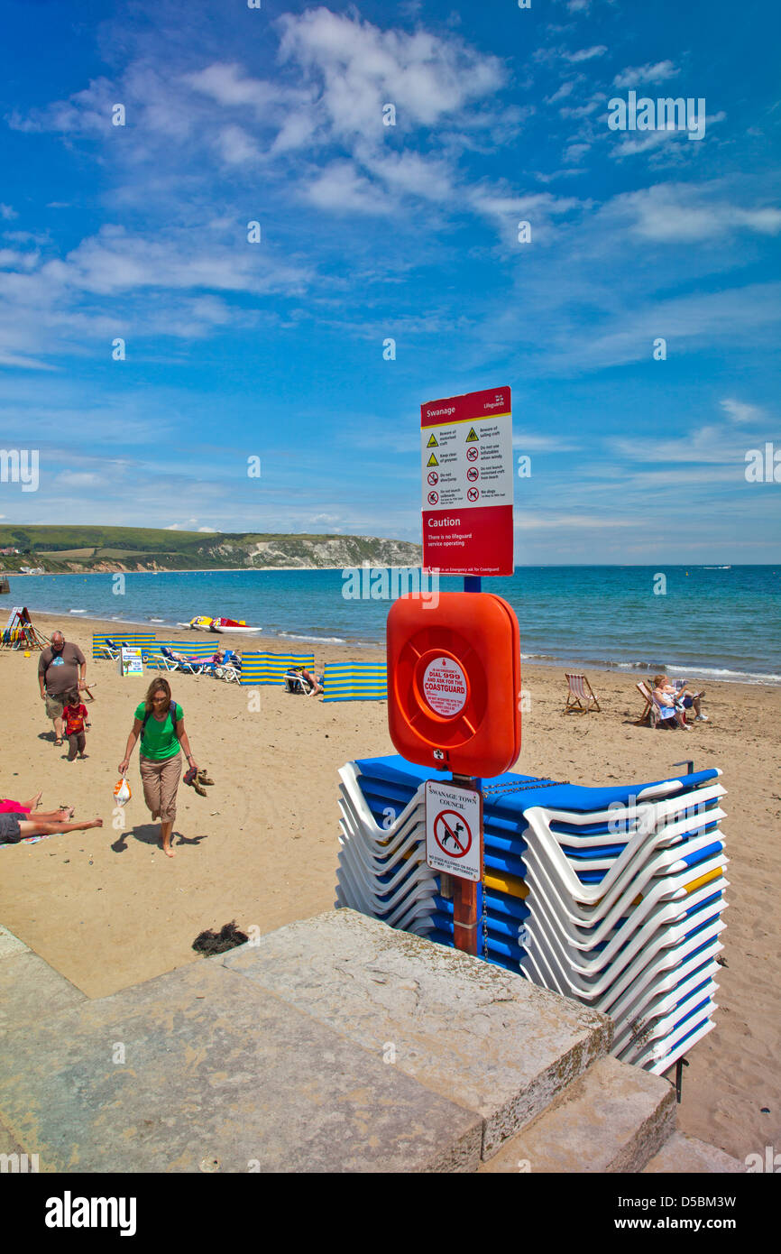 Beach sign and sun loungers for hire on Swanage beach in Dorset England UK Stock Photo