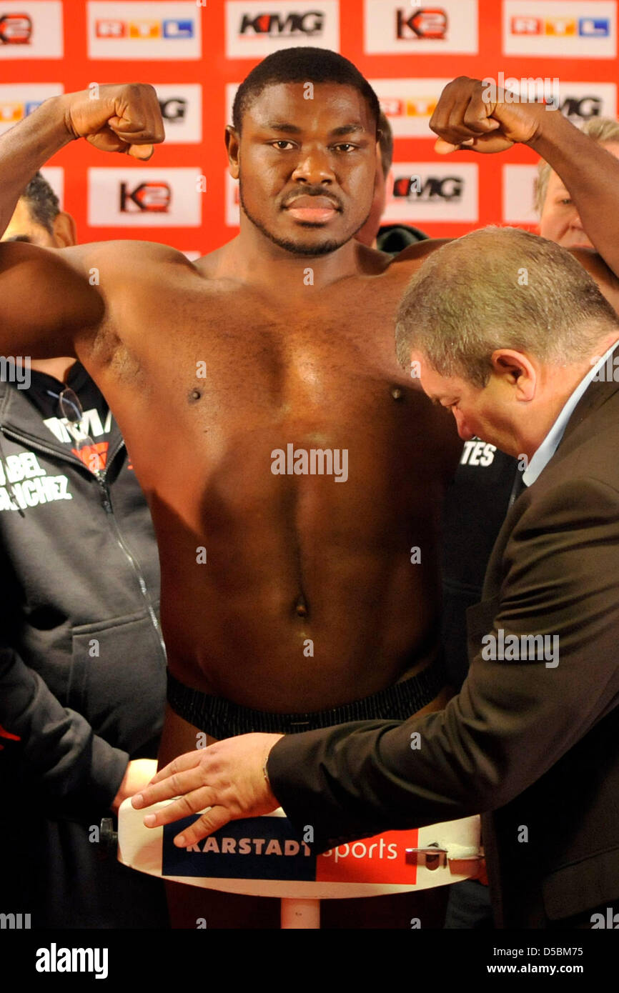 Nigerian heavyweight boxer Samuel Peter poses on the scales at the ...