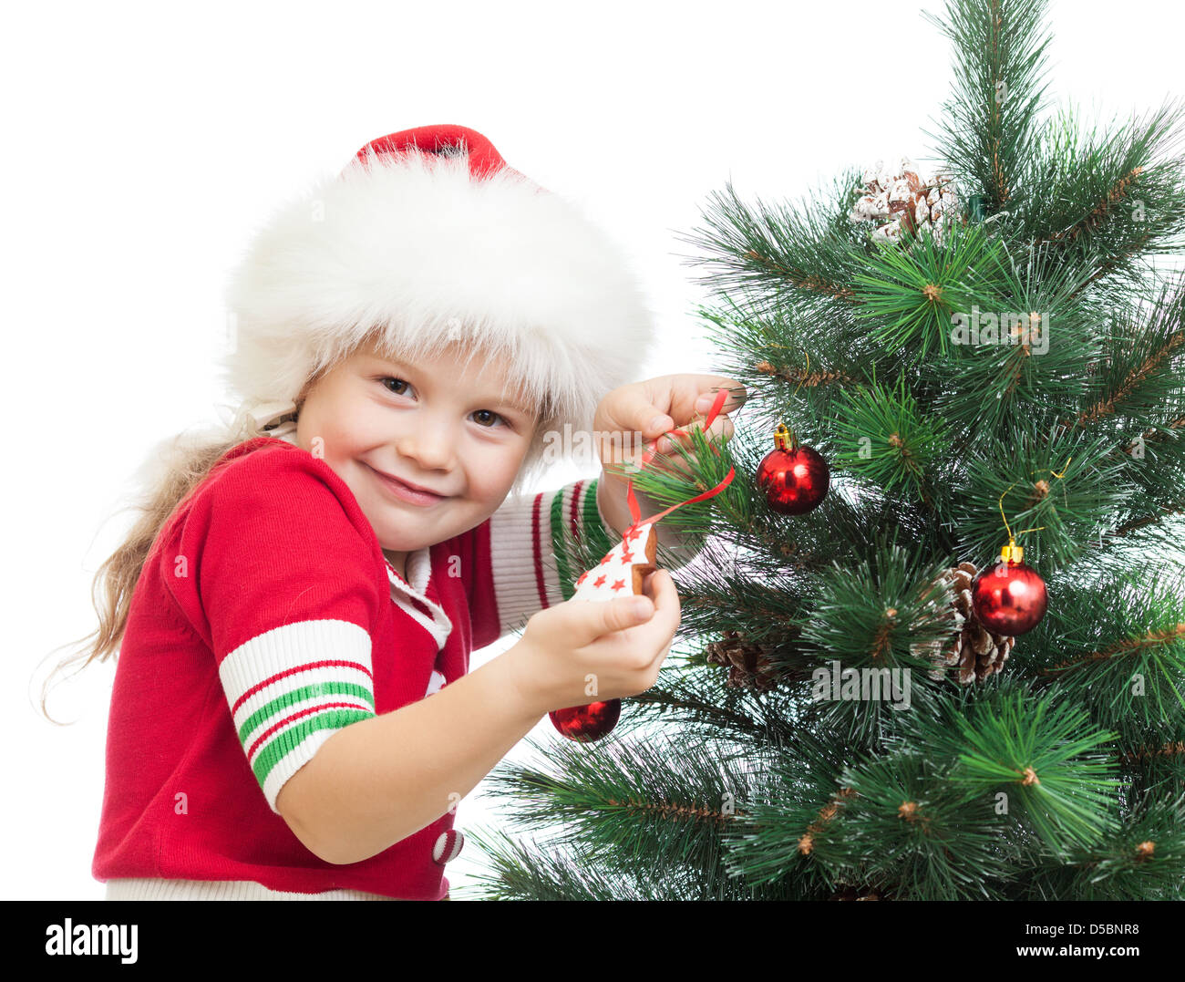 happy preschool girl decorating Christmas tree isolated on white Stock Photo