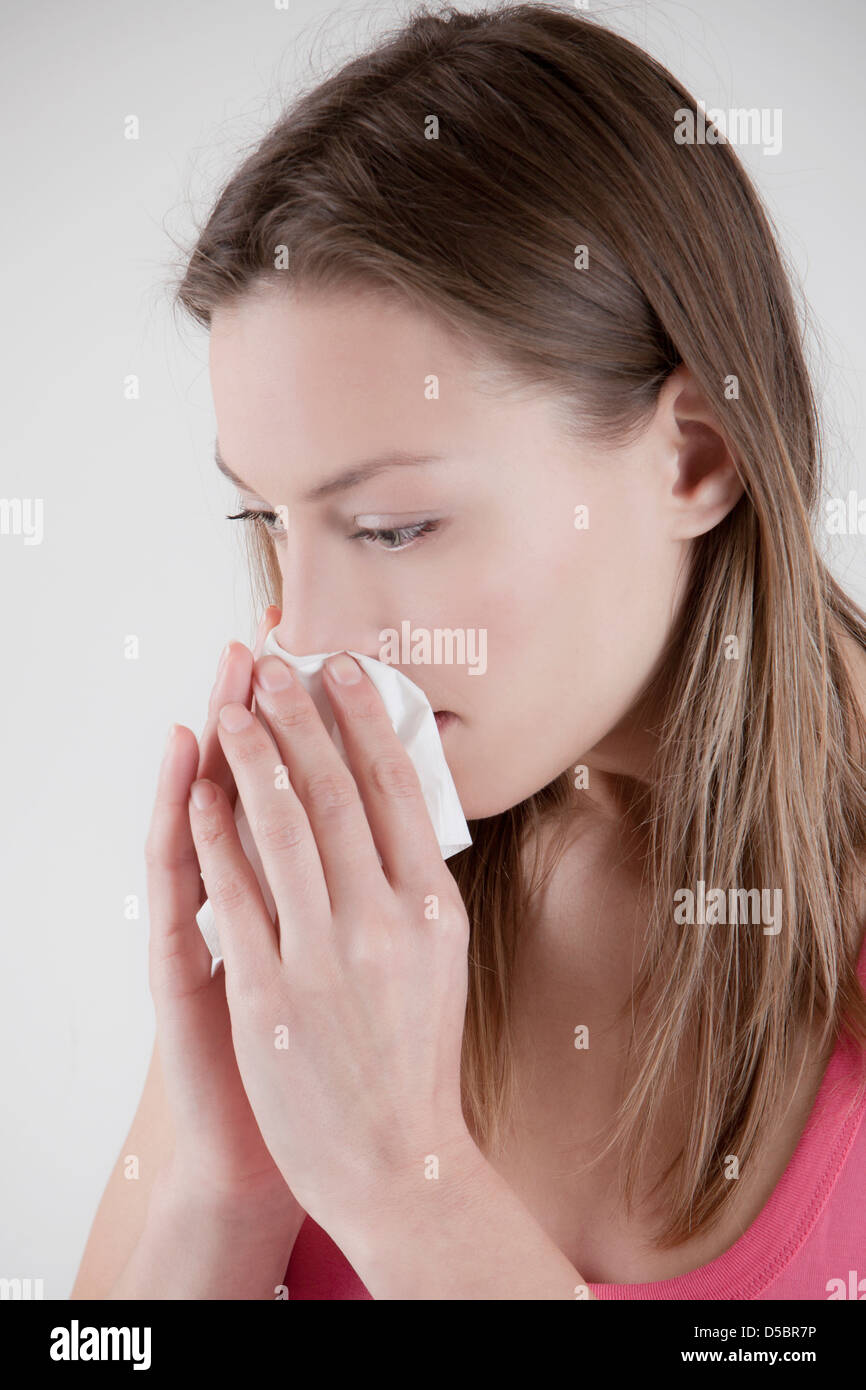woman blows her nose Stock Photo