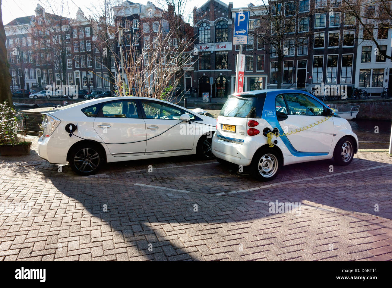 Eco battery powered cars recharging Stock Photo Alamy