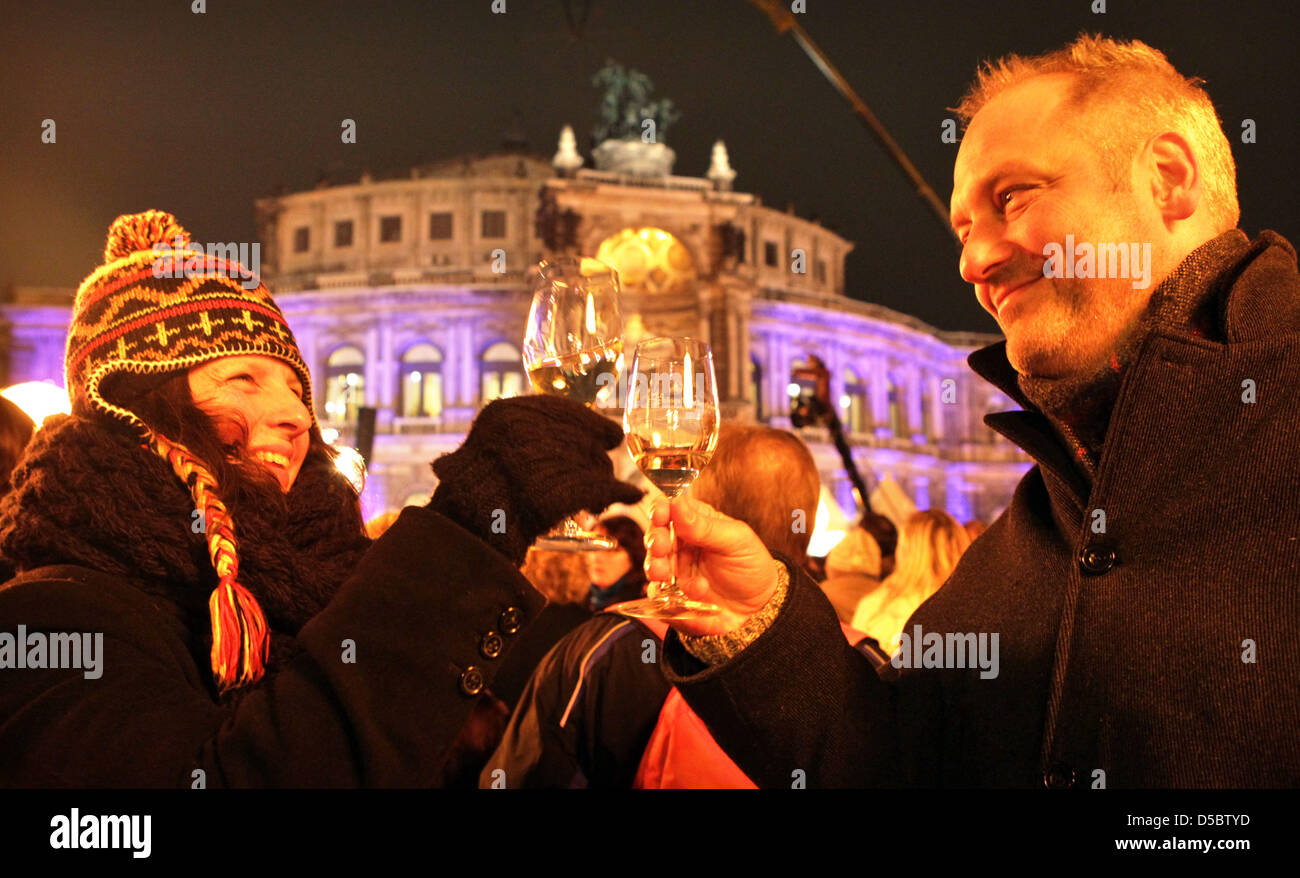 Grit Stolz from Berlin and her friend Philip Welker from Stuttgart clink glasses together with a Schloss Wackerbarth in front of the illuminated Semper opera to the 5th Semper opera ball in Dresden, Germany, 15 January 2010. Over 2,000 guests from economy, politics and culture celebrated under the motto 'Dreamteams' a ball night in the theatre built by Gottfried Semper (1803-1879). Stock Photo