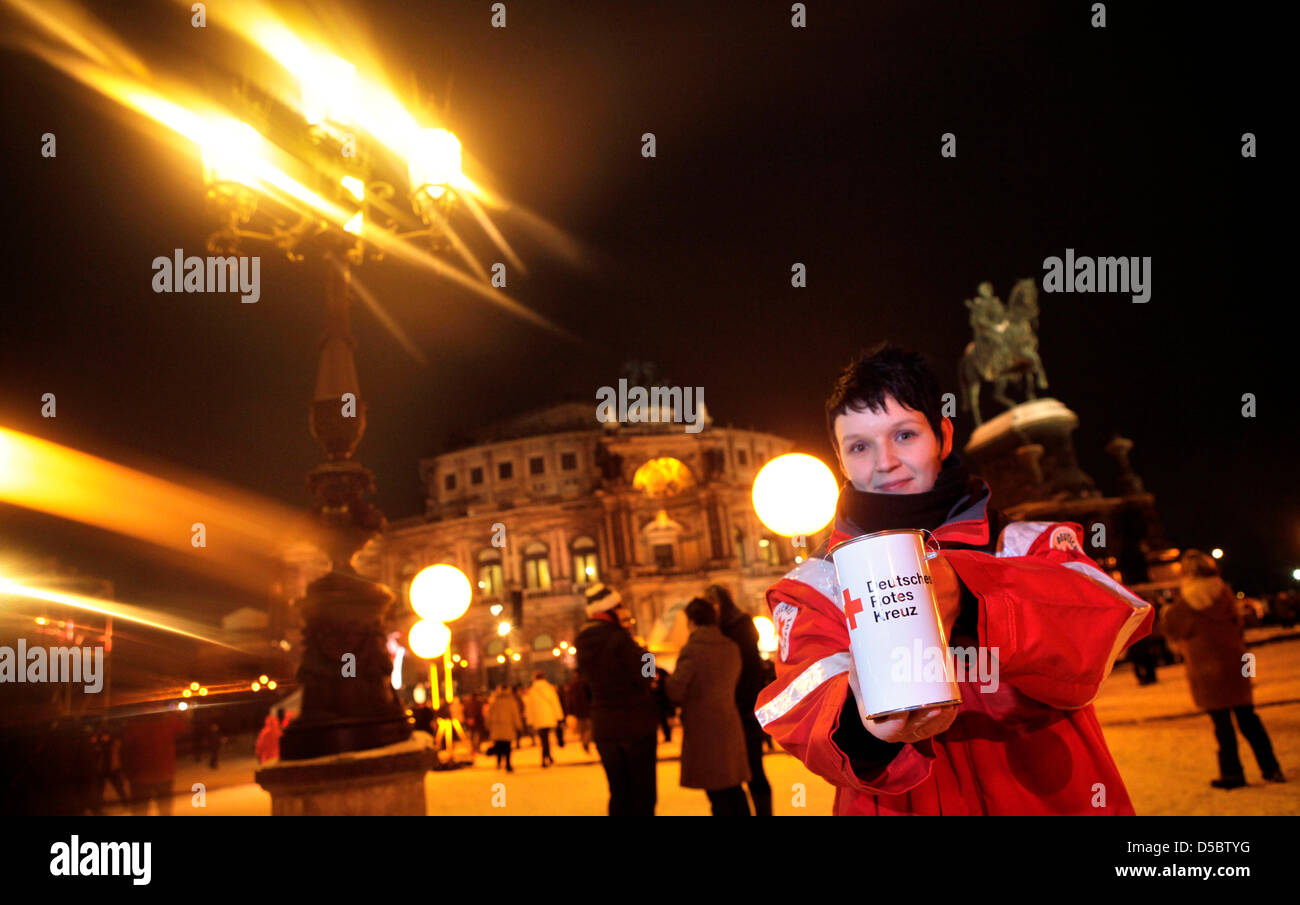 A employee of the German Red Cross collects donations for the earthquake victims in Haiti at the 5th Semper opera ball in Dresden, Germany, 15 January 2010. Over 2,000 guests from economy, politics and culture celebrated under the motto 'Dreamteams' a ball night in the theatre built by Gottfried Semper (1803-1879). Stage and auditorium of the Semper opera were remodeled for this ev Stock Photo