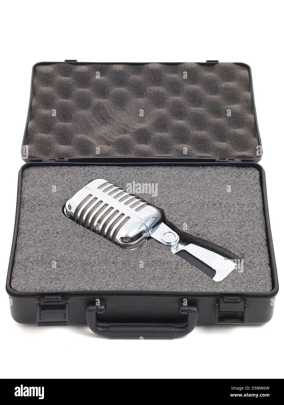 Retro microphone inside a briefcase. The microphone is lying Stock