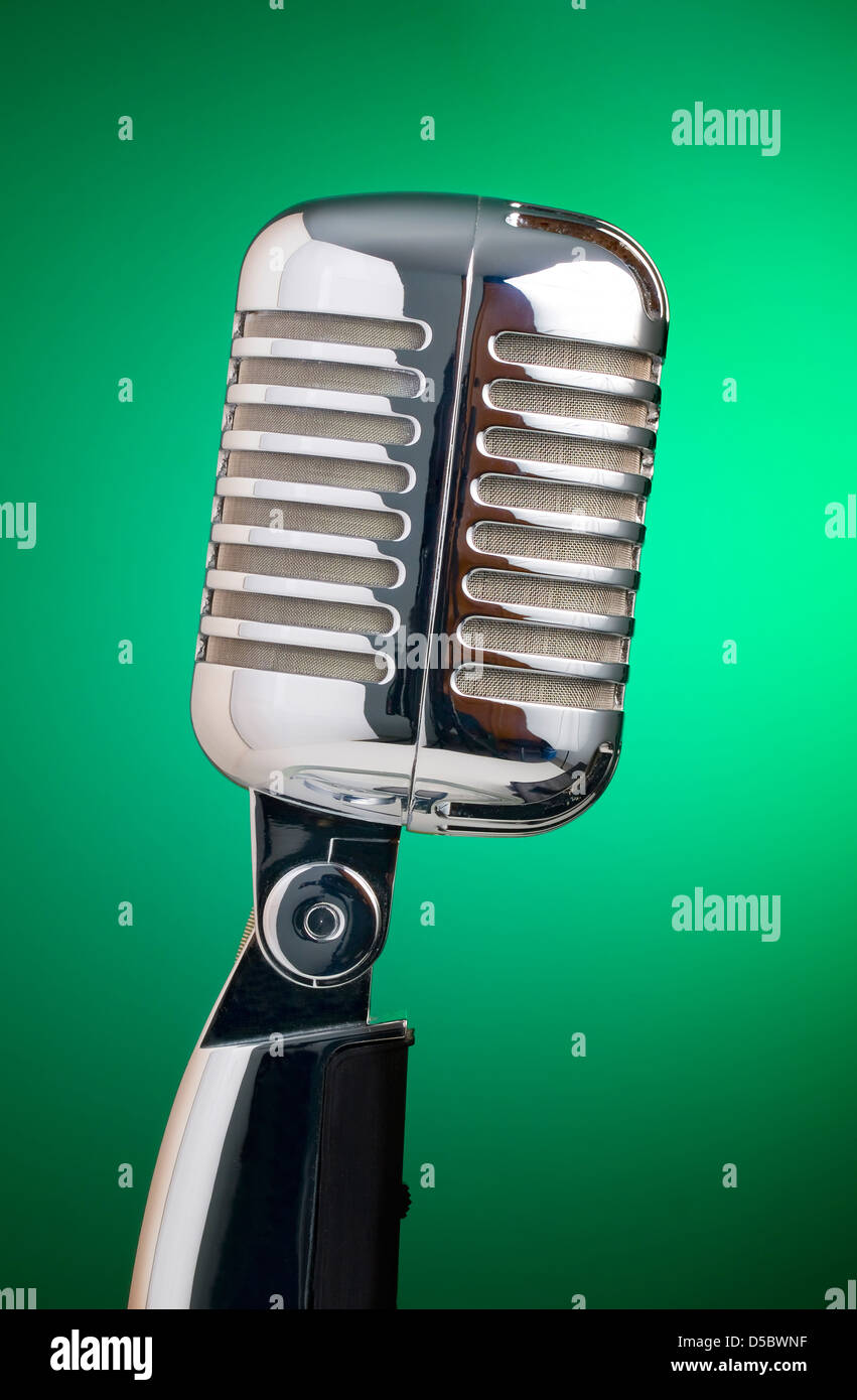 Classic microphone isolated on green background in vertical composition Stock Photo