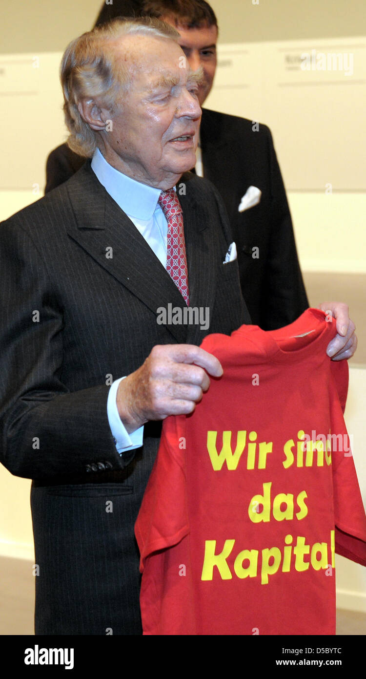ThyssenKrupp's honorary chairman Berthold Beitz holds a shirt labelled