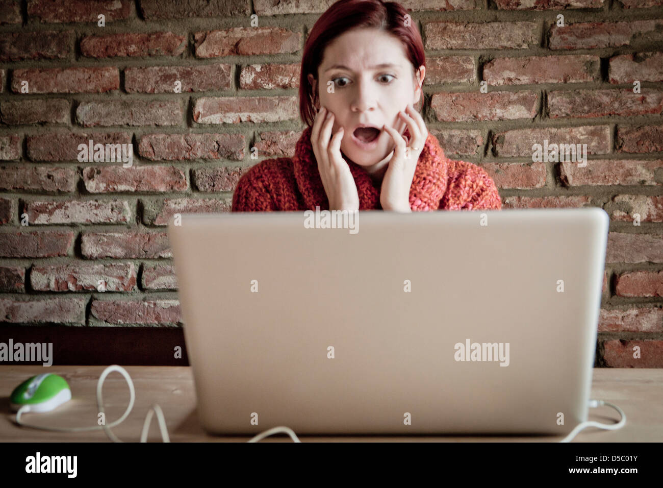 distraught woman looking the laptop Stock Photo