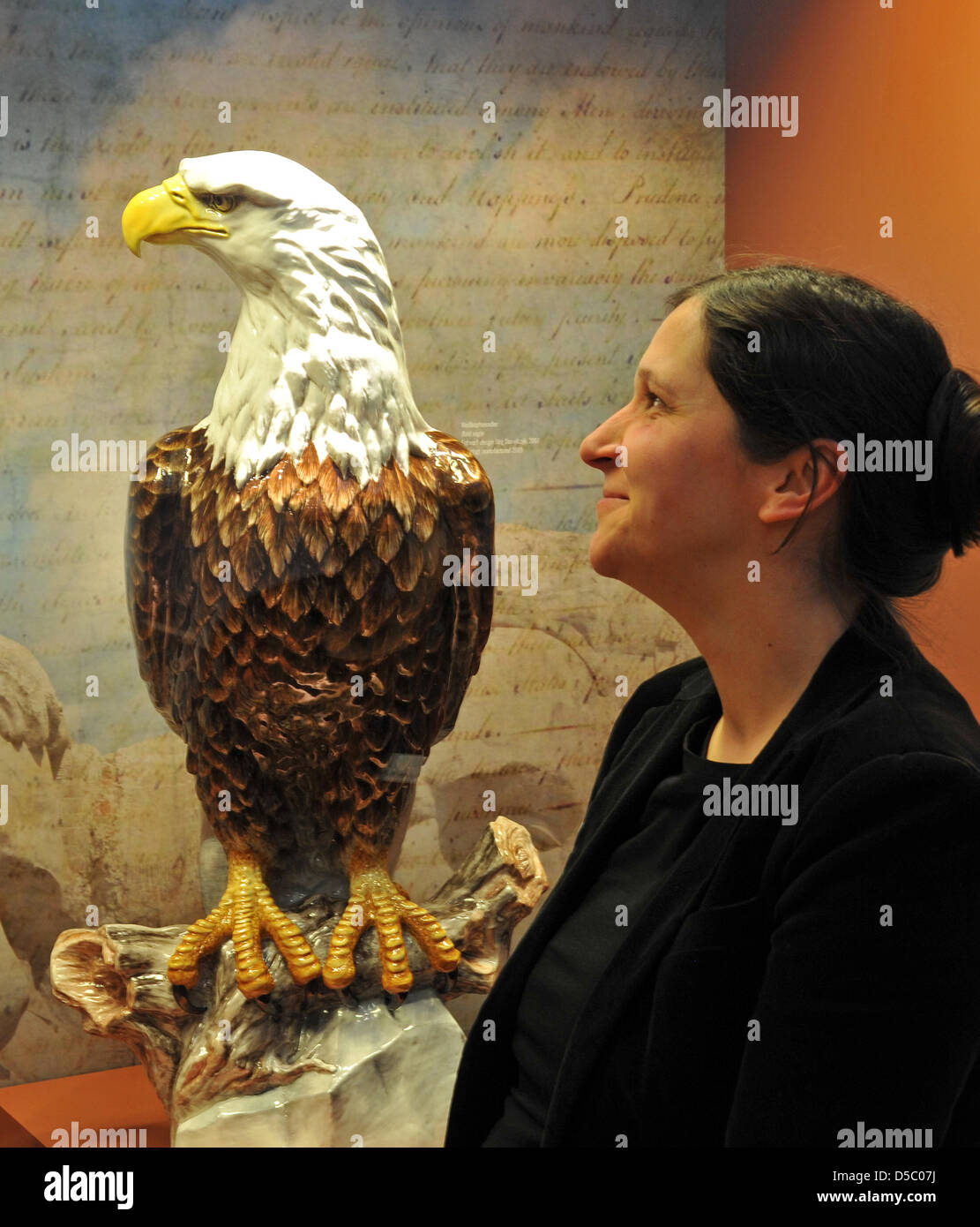 A staff member of Meissen Porcelain Manufactory eyes a sculpture of US heraldic animal, a bald eagle, that is part of the exhibition celebrating the 300th anniversary of Meissen Porcelain in Meissen, Germany, 20 January 2010. The exhibition 'All Nations Are Welcome' is the company's largest special exhibition and will open on 23 January 2010. In 2008, the manufactory with the 'cros Stock Photo