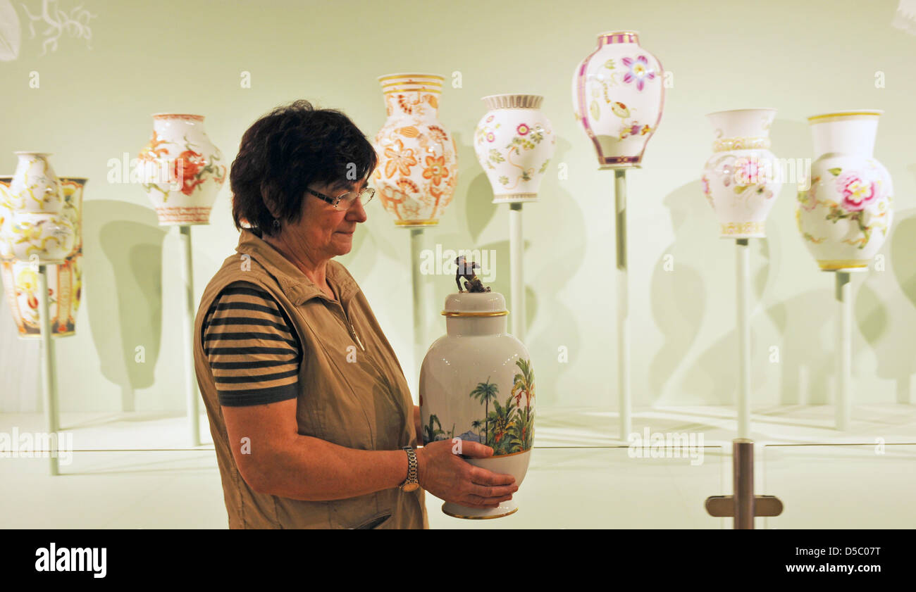 A staff member of Meissen Porcelain Manufactory eyes a vase that is part of the exhibition celebrating the 300th anniversary of Meissen Porcelain in Meissen, Germany, 20 January 2010. The exhibition 'All Nations Are Welcome' is the company's largest special exhibition and will open on 23 January 2010. In 2008, the manufactory with the 'crossed swords' trademark reported a sales vol Stock Photo
