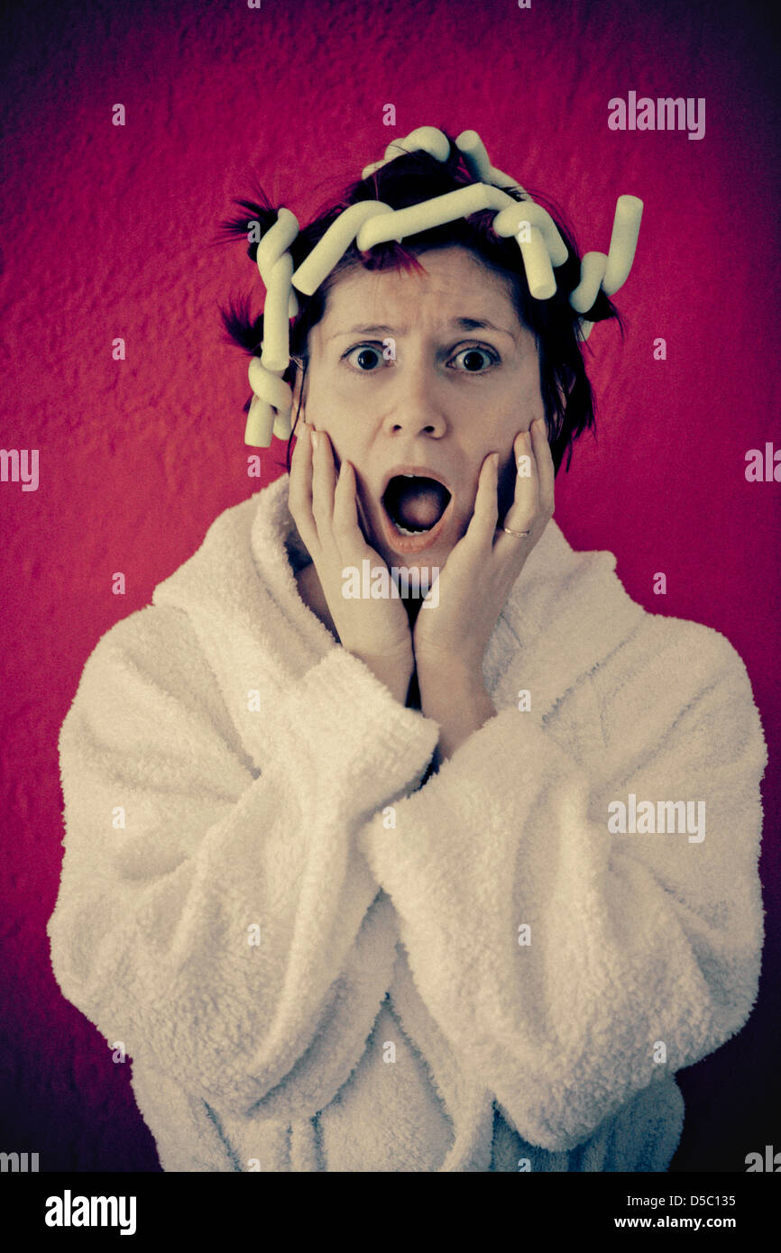 woman in bathrobe and curlers Stock Photo Alamy