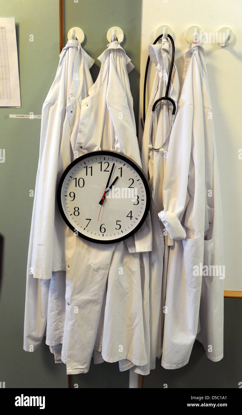 A clock and several doctor's overalls hang in a room at the Park Hospital in Leipzig, Germany, 20 January 2010. The department of Clinical and Interventional Angiology is Germany's largest and high-performing centre and is also at the forefront throughout Europe. In collaboration with the Heart Centre Leipzig, an international congress for vascular surgeons with a parallel event in Stock Photo