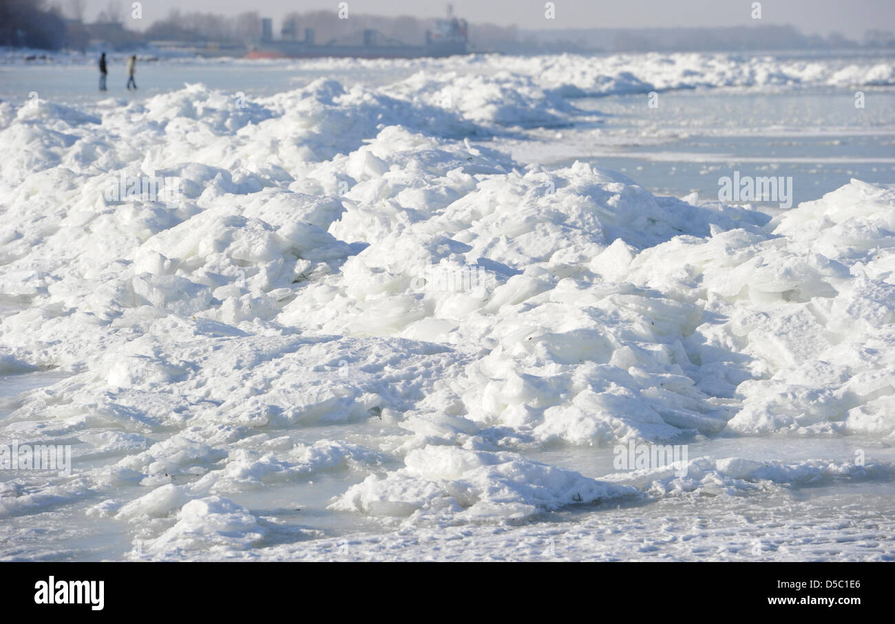 Tourists walk past ice waves at the beach of the coastal resort Lubmin
