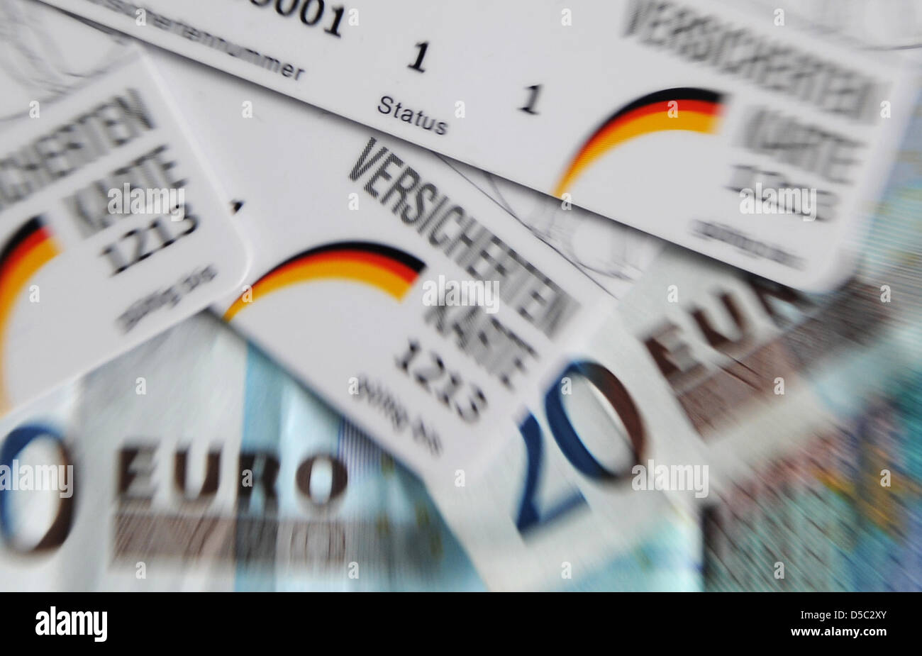 Health insurance cards lie on a table in Duesseldorf, Germany, 27 January 2010. Some statutory health insurances plan to collect additional contributions of eight euros from their customers. Photo: Achim Scheidemann Stock Photo