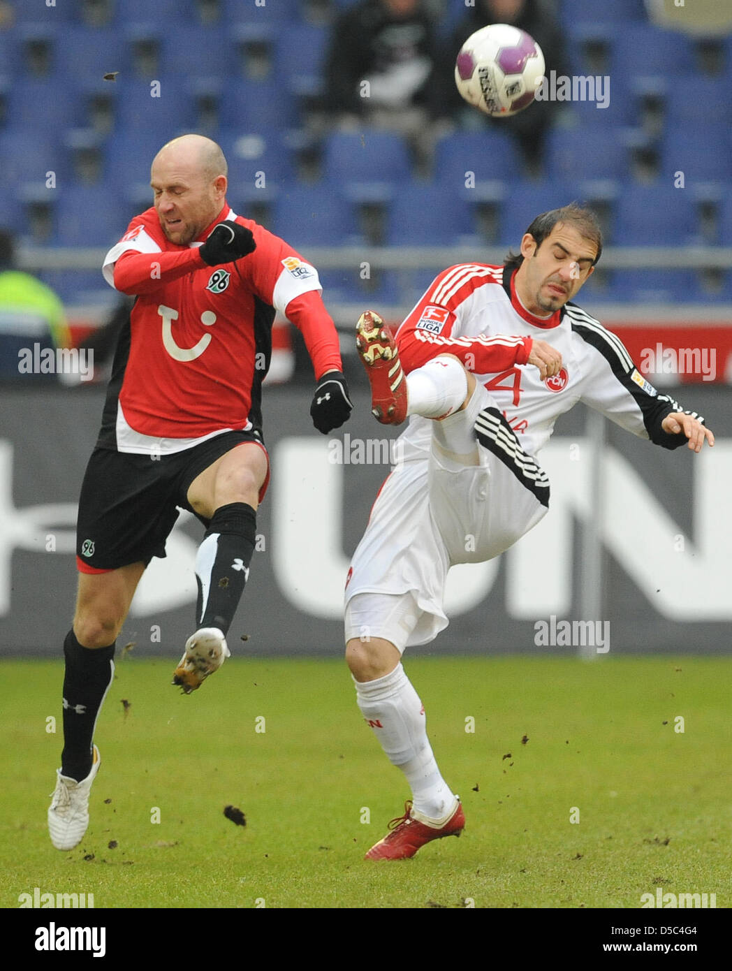 Hanover's Jiri Stajner (L) fights for the ball with Nuremberg's Javier Pinola during the German Bundesliga match Hanover 96 vs 1. FC Nuremberg at AWD-Arena stadium in Hanover, Germany, 30 January 2010. Nuremberg defeated Hanover 3-1. Photo: PETER STEFFEN (ATTENTION: EMBARGO CONDITIONS! The DFL permits the further utilisation of the pictures in IPTV, mobile services and other new te Stock Photo