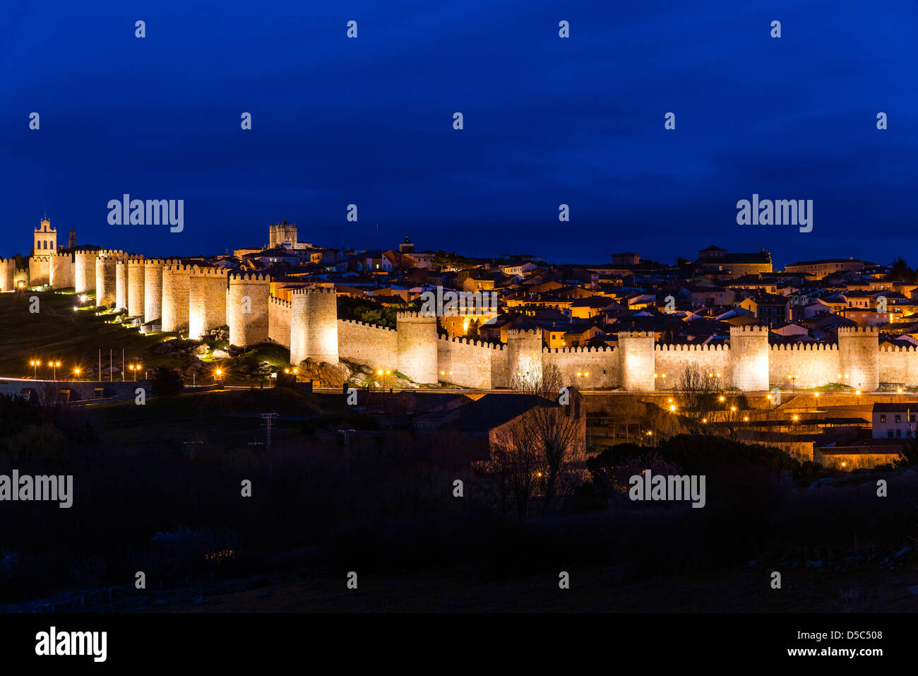 View from Cuatro Postes over the medieval city walls illuminated at night, Avila, Castile and León, Spain Stock Photo