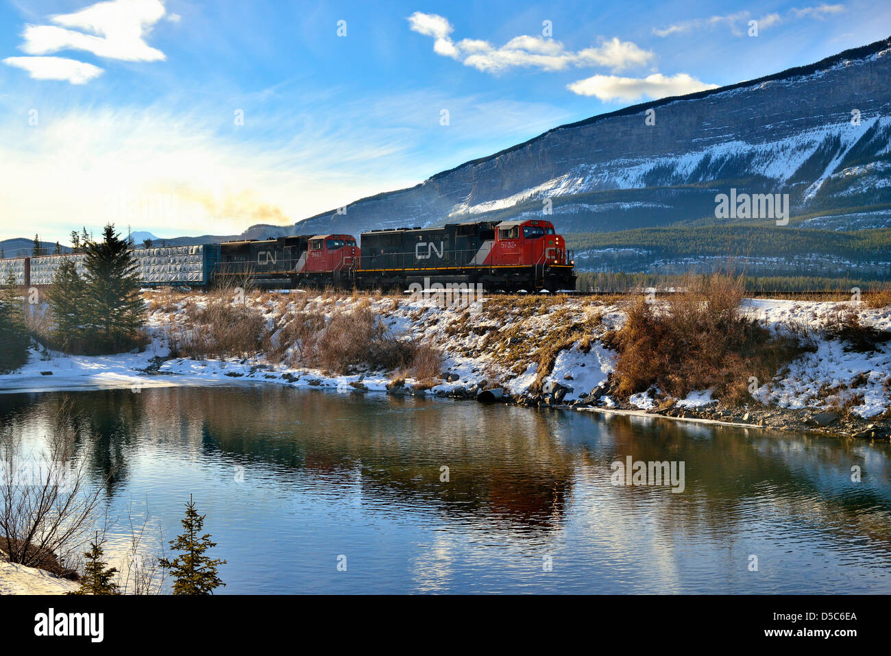 A Canadian National freight train traveling east through the rocky mountains. Stock Photo