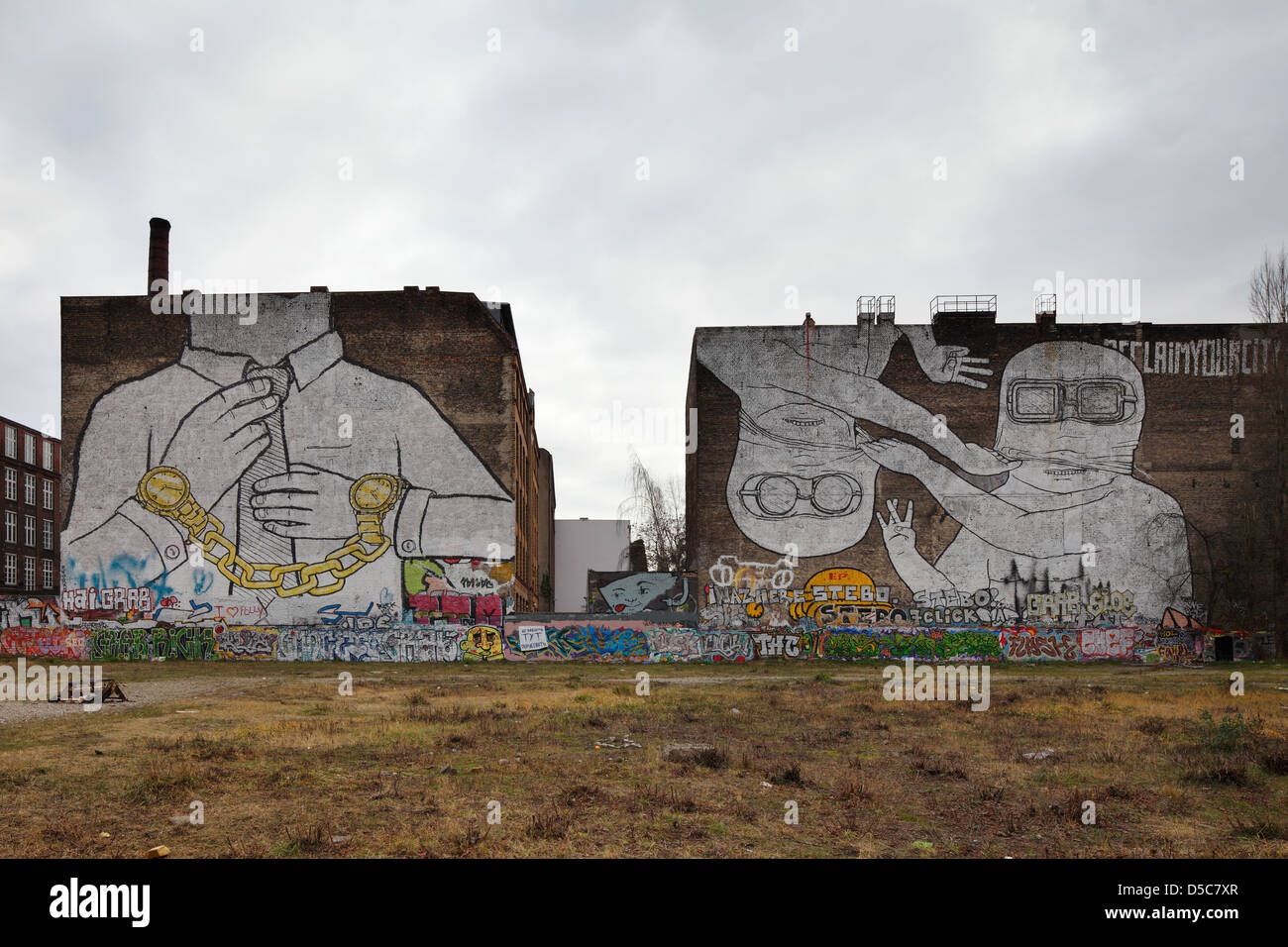 Berlin, Germany, Undeveloped Land, graffiti from blu and JR Stock Photo
