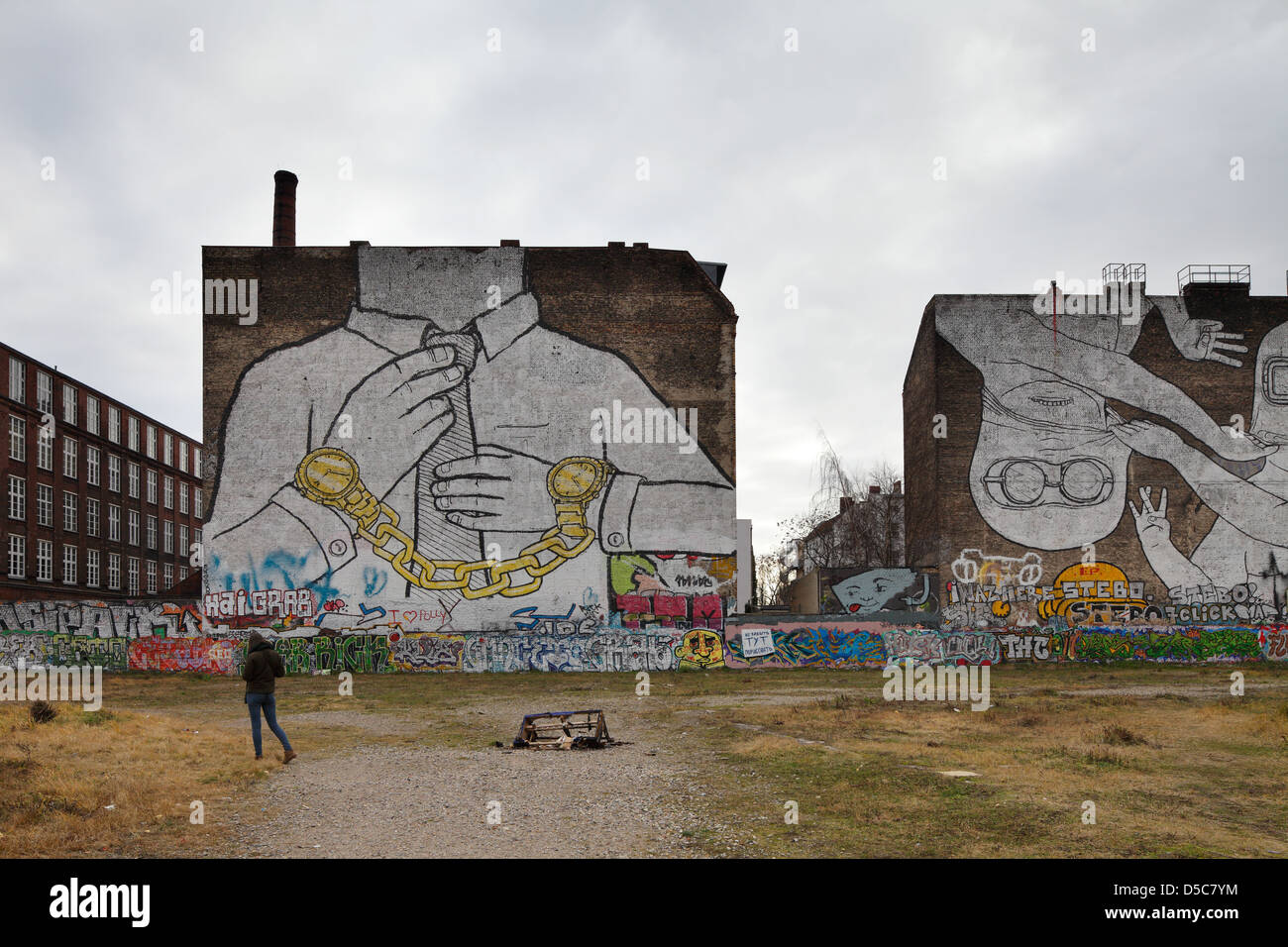 Berlin, Germany, Undeveloped Land, graffiti from blu and JR Stock Photo