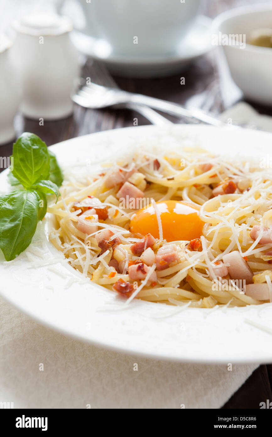 pasta carbonara with egg yolk in the middle, closeup Stock Photo Alamy