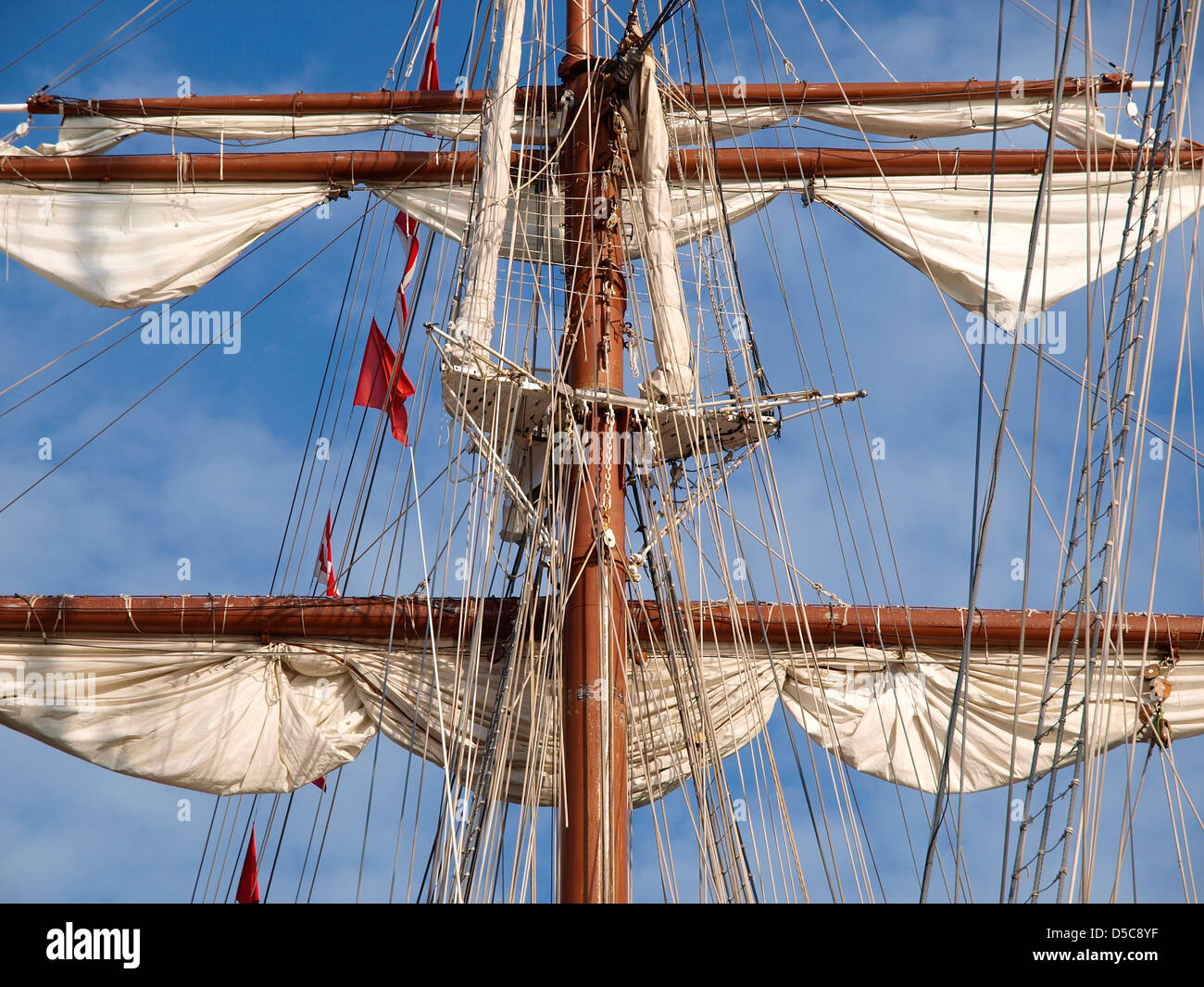 Mast of a ship with furled sails detail Stock Photo - Alamy