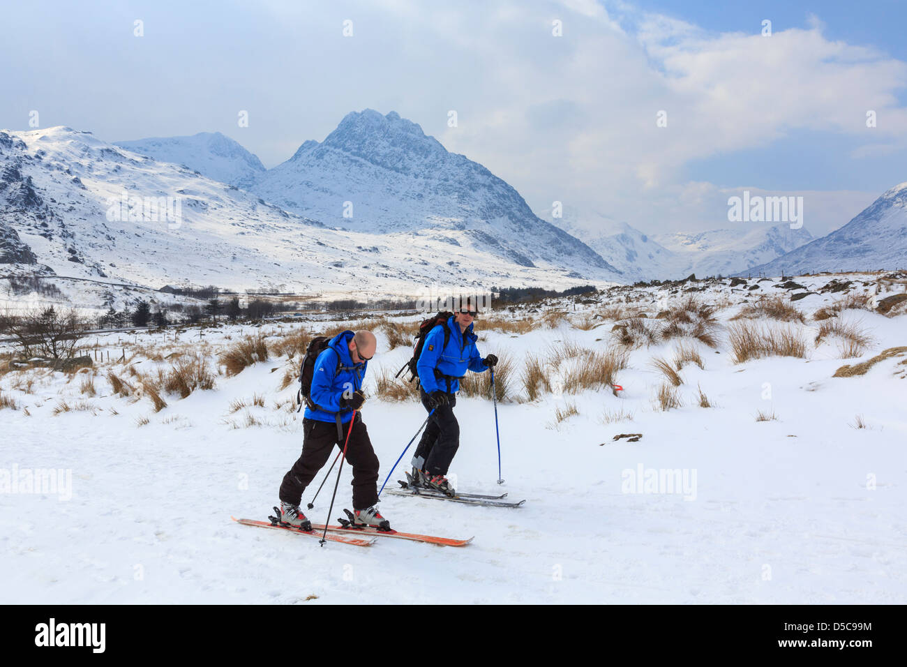 Skiers head up into Carneddau mountains of Snowdonia after heavy snowfall  with view to Tryfan mountain in Ogwen, North Wales, UK Stock Photo - Alamy