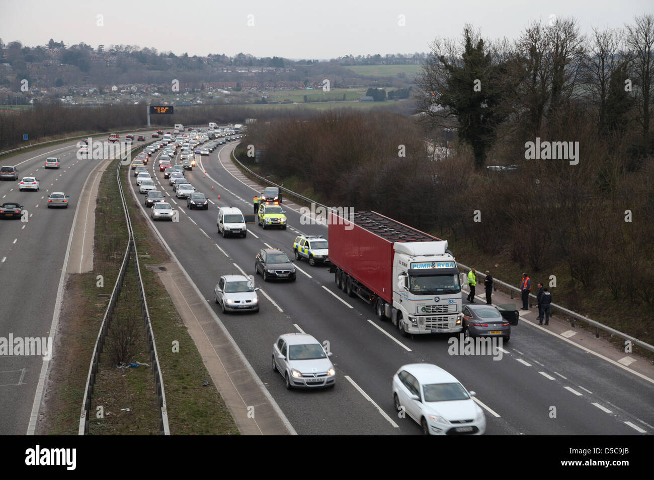 Winchester,UK. 28 March 2013 - Police & highway patrol attending an incident on the M3 motorway between Jct. 10 & 11 in Hampshire involving an articulated lorry and a Renault Laguna. Nobody appeared to be injured but the incident caused tailbacks for an hour. Stock Photo