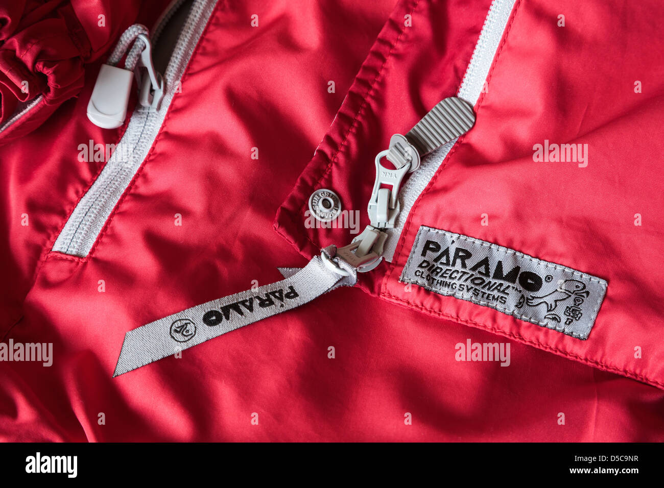 Close-up of a Nikwax Analogy Paramo directional clothing label on a red Alta II waterproof jacket. UK Stock Photo