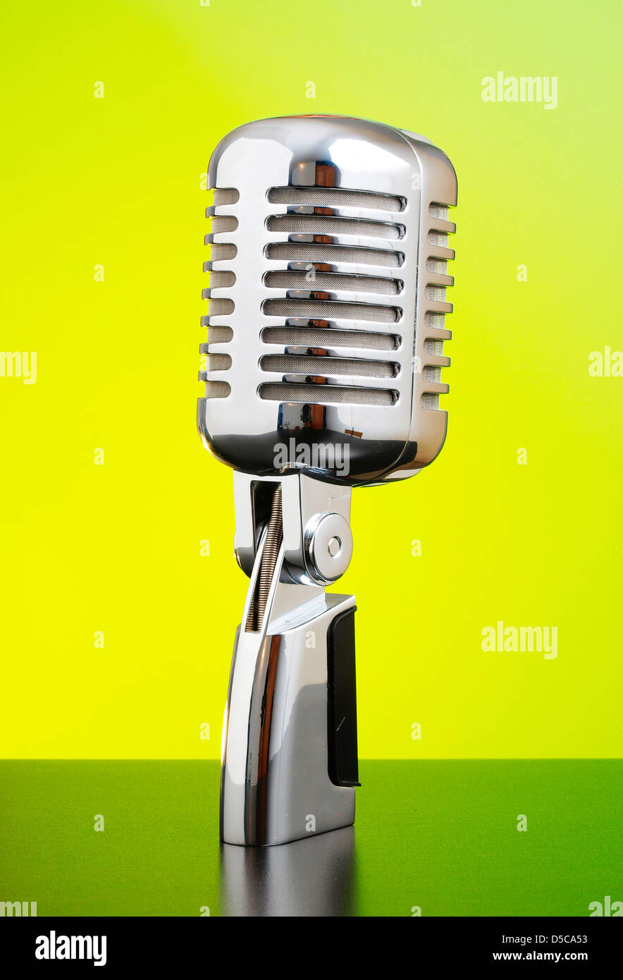 Classic microphone on yellow and green background Stock Photo