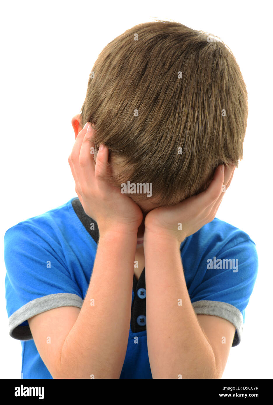 Boy holding his head in his hands Stock Photo