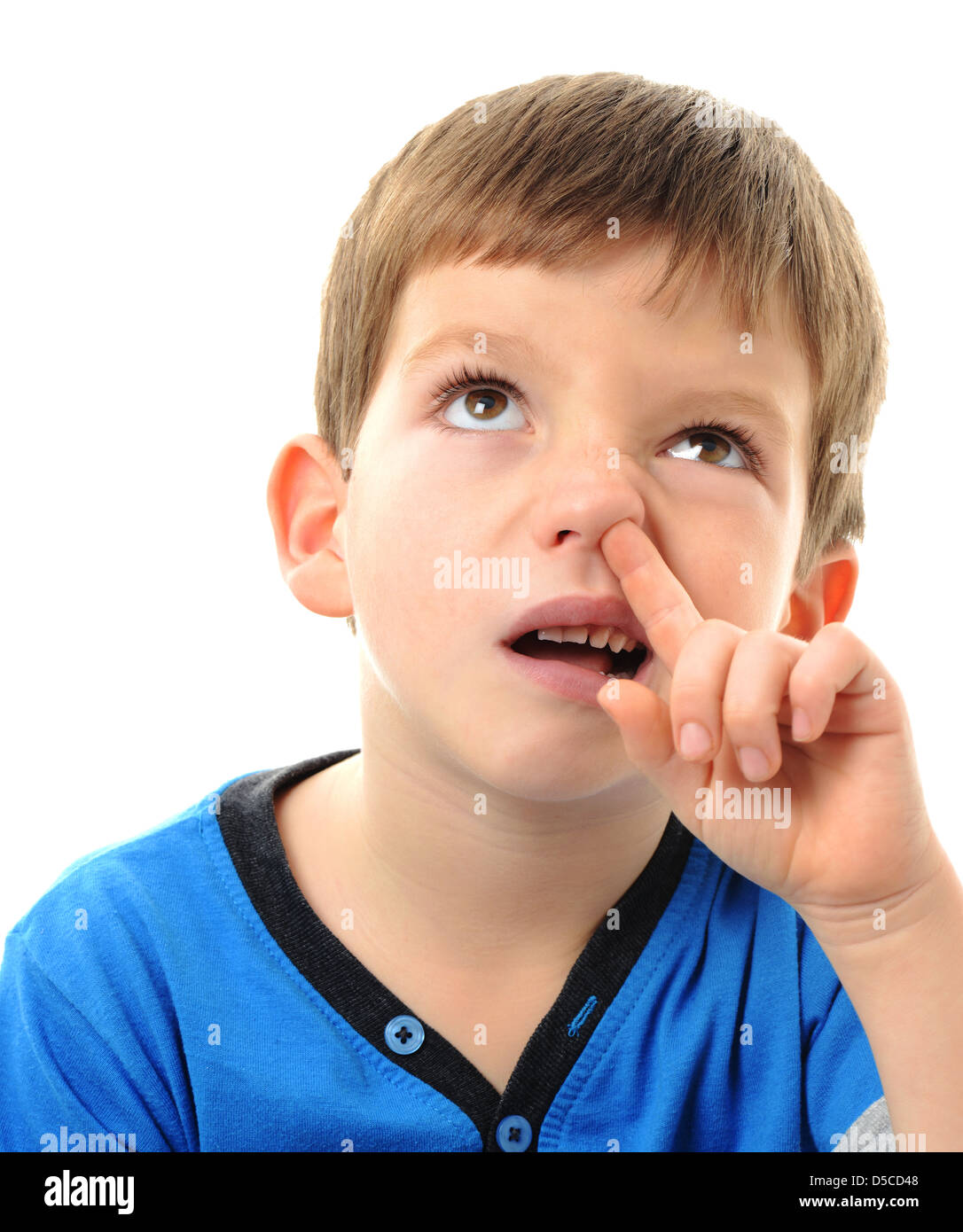 Boy picking his nose, young child picking their nose Stock Photo