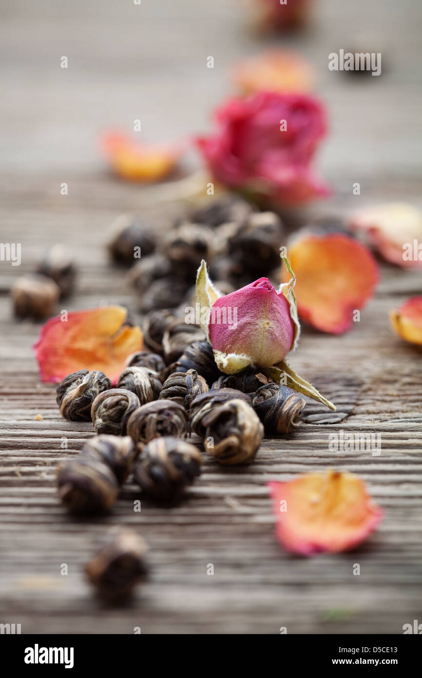 Fresh green tea leaves with rose buds Stock Photo