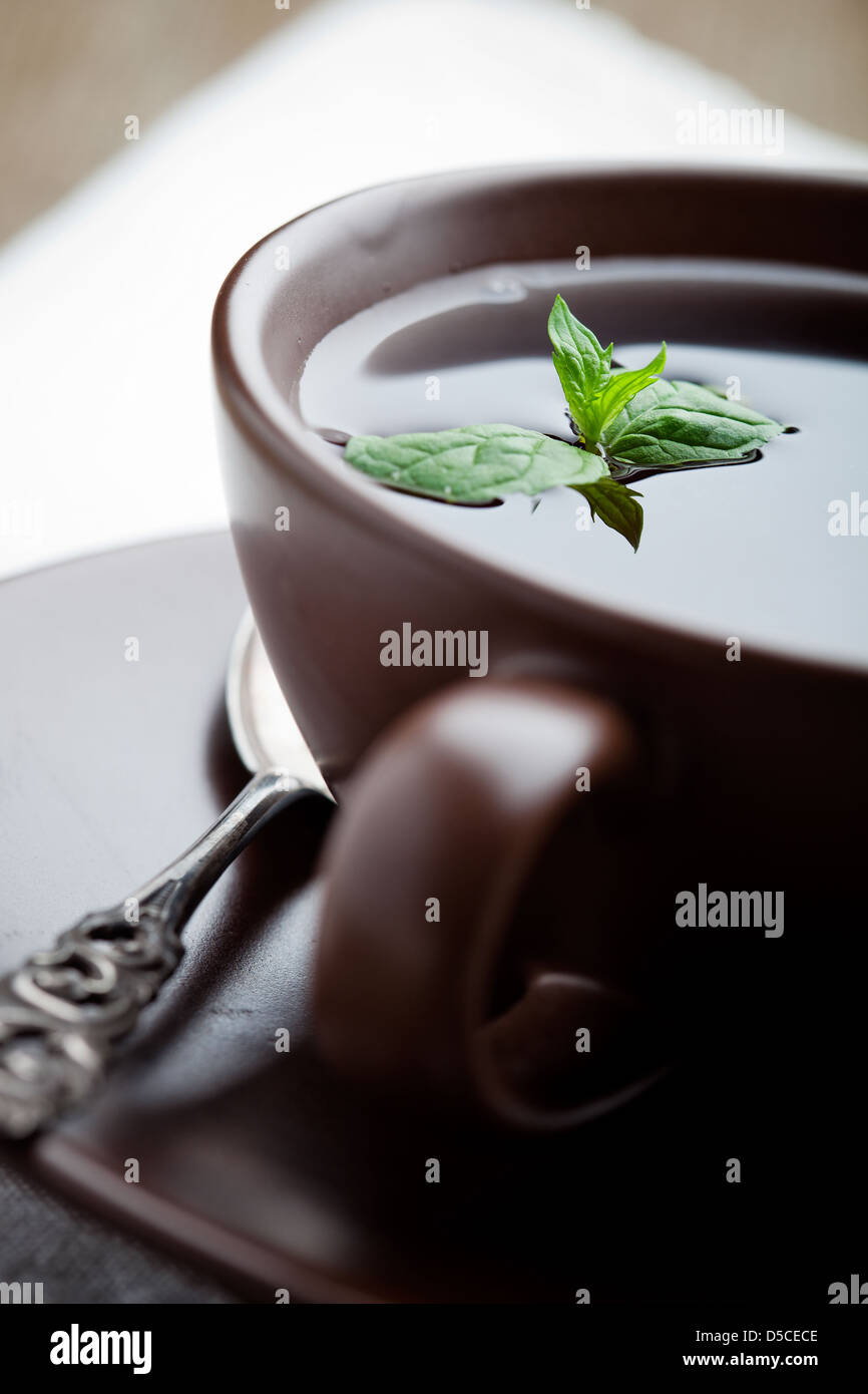 Fresh tea in brown cup, selective focus Stock Photo