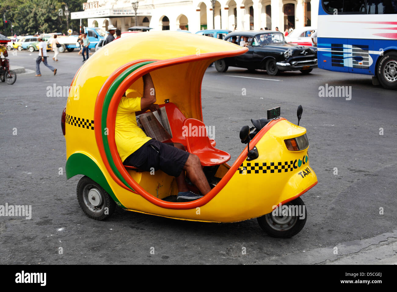Yellow Coco Taxi In Central Havana Cuba Waiting For A Fare, The Coco Taxi Is A Three Wheeled Motorized Rickshaw Stock Photo