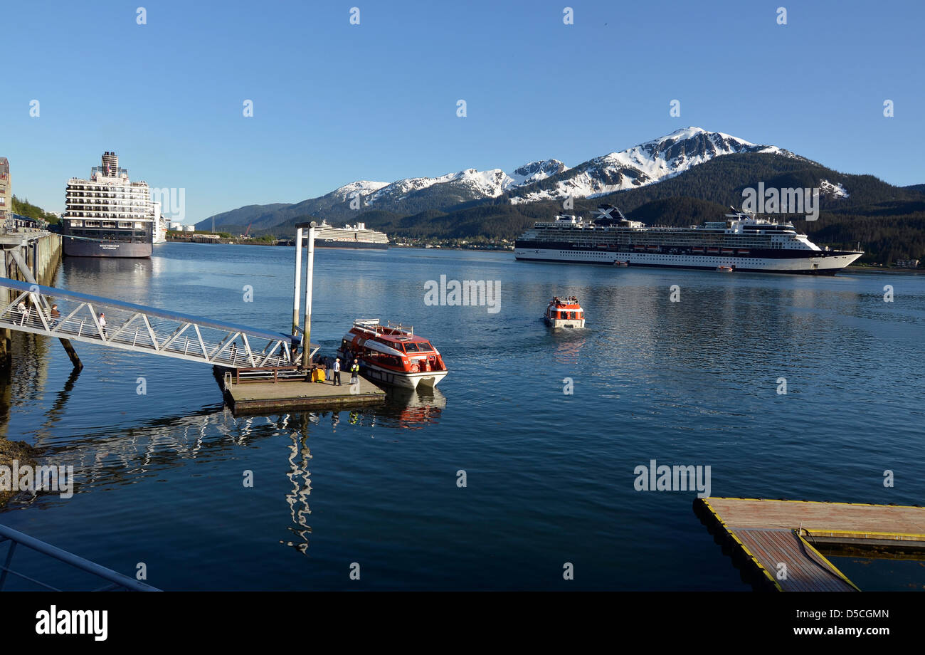 Shuttle boats ferrying tourists to cruise ship anchored in Juneau, Alaska. Stock Photo