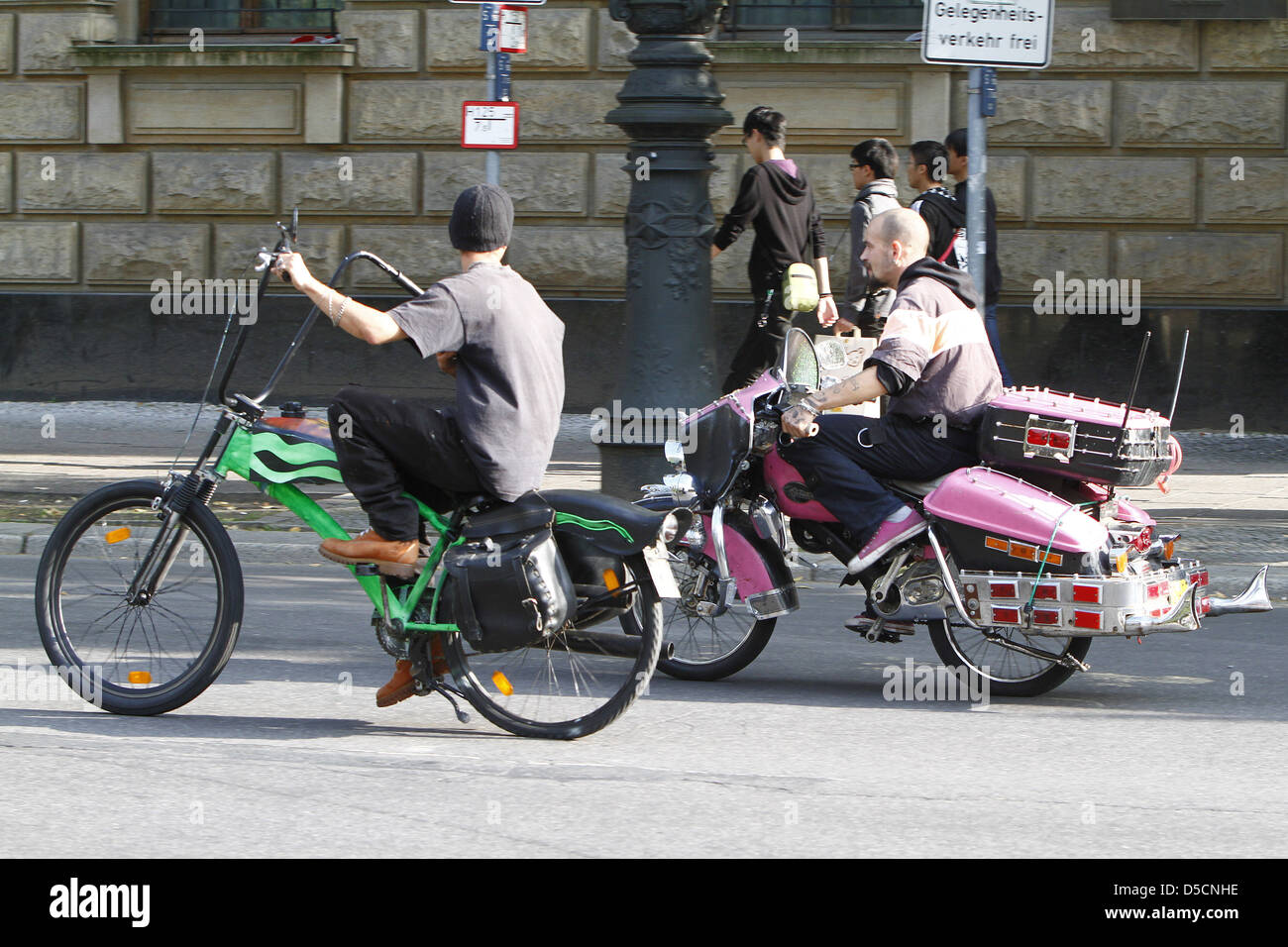 Riders on bicycles designed like chopper motorbikes riding on Unter den ...