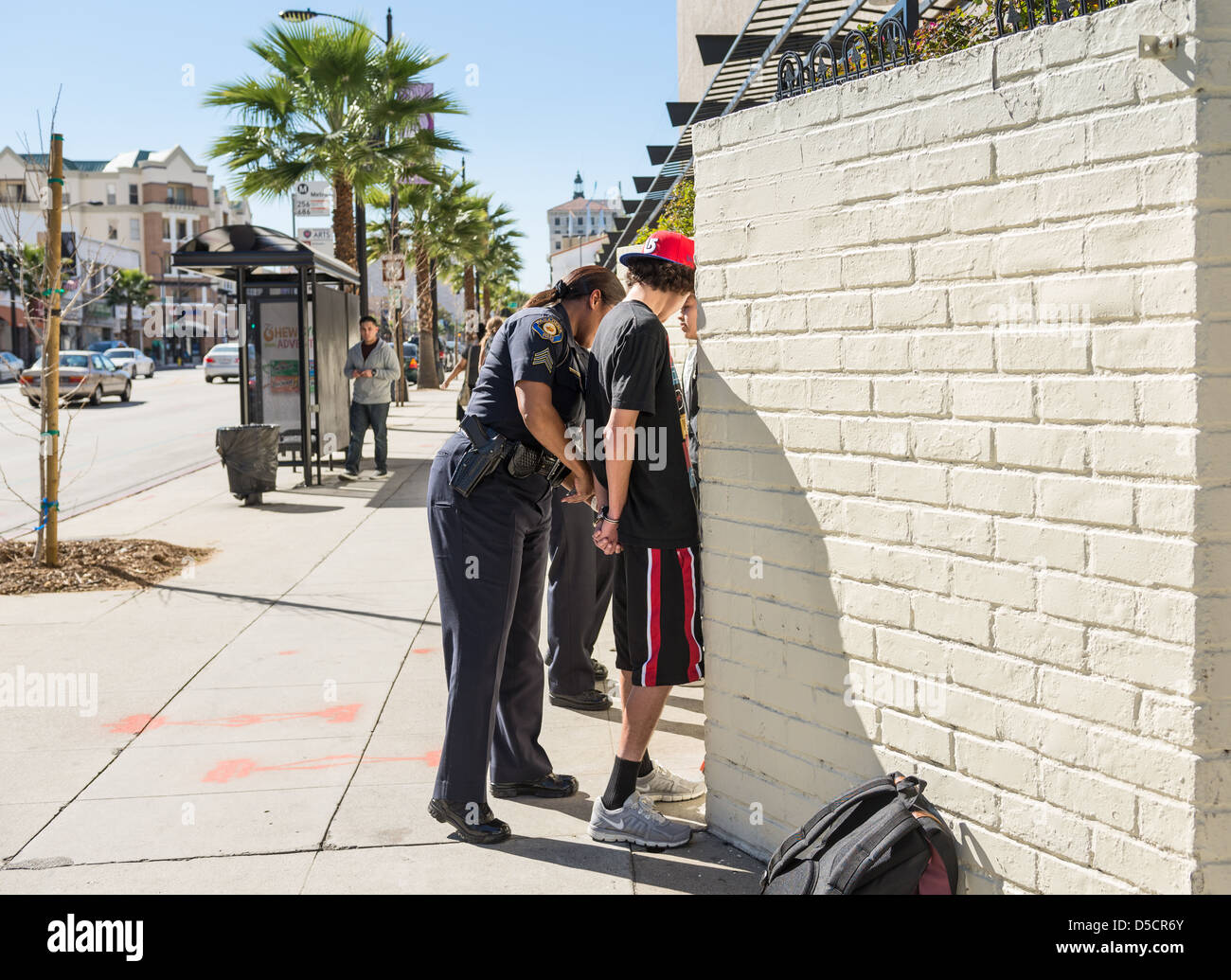 Teenagers getting arrested on the streets. Stock Photo