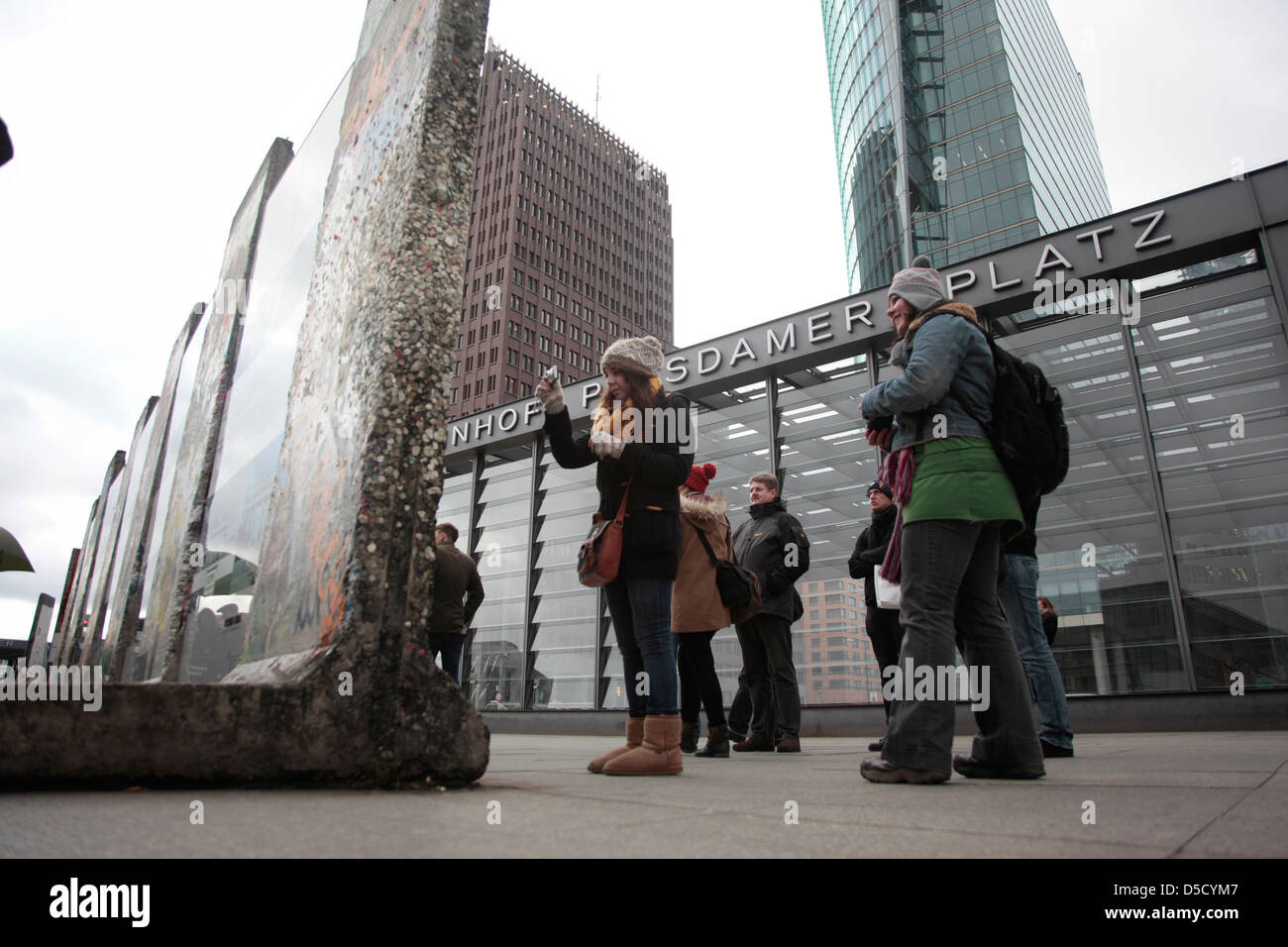 Berlin, Germany, tourists wrap the remains of the wall at Potsdamer Platz with chewing gum Stock Photo