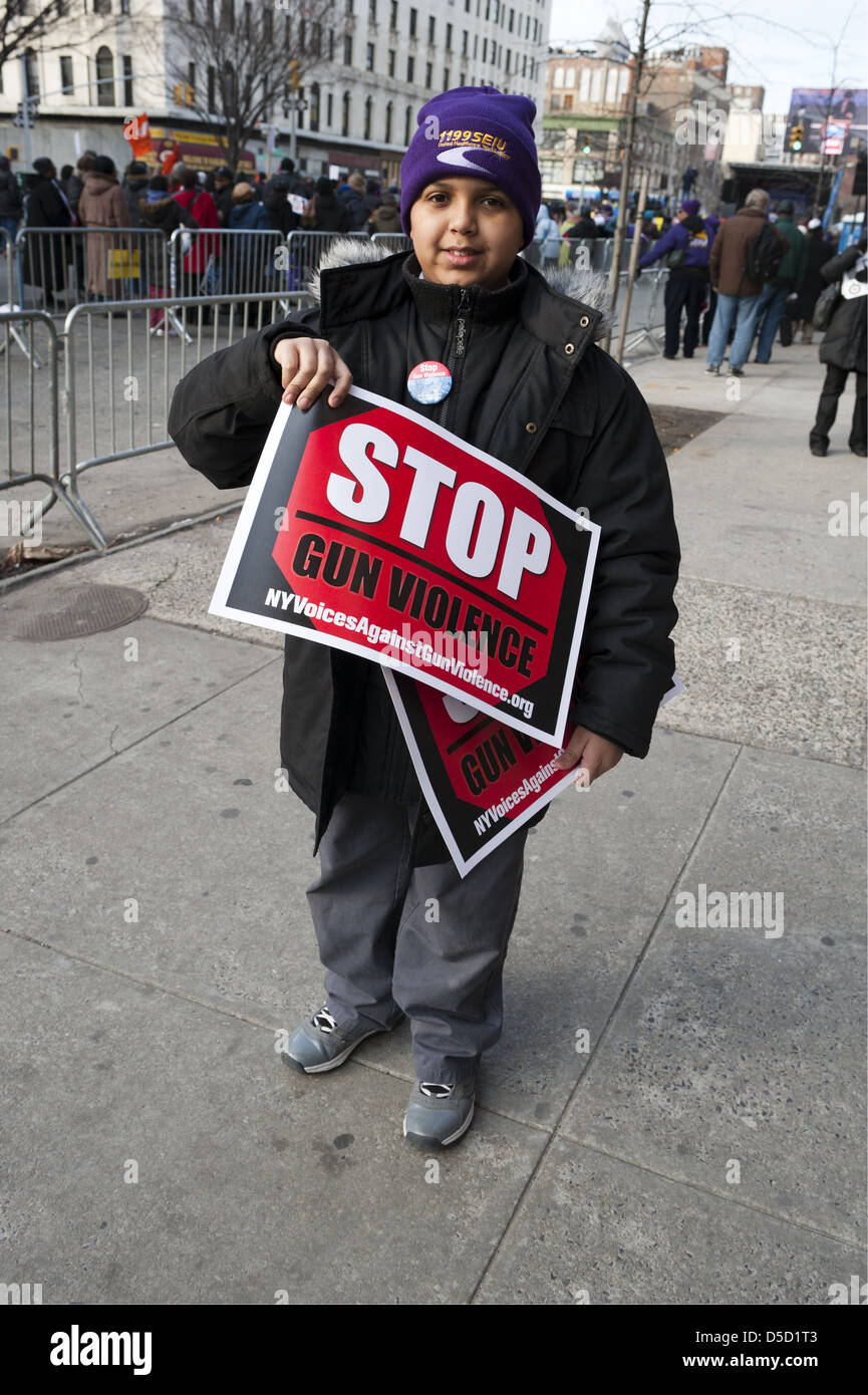 Anti-gun rally in the Harlem neighborhood of Manhattan, on March 21, 2013. Hispanic boy handing out signs. Stock Photo
