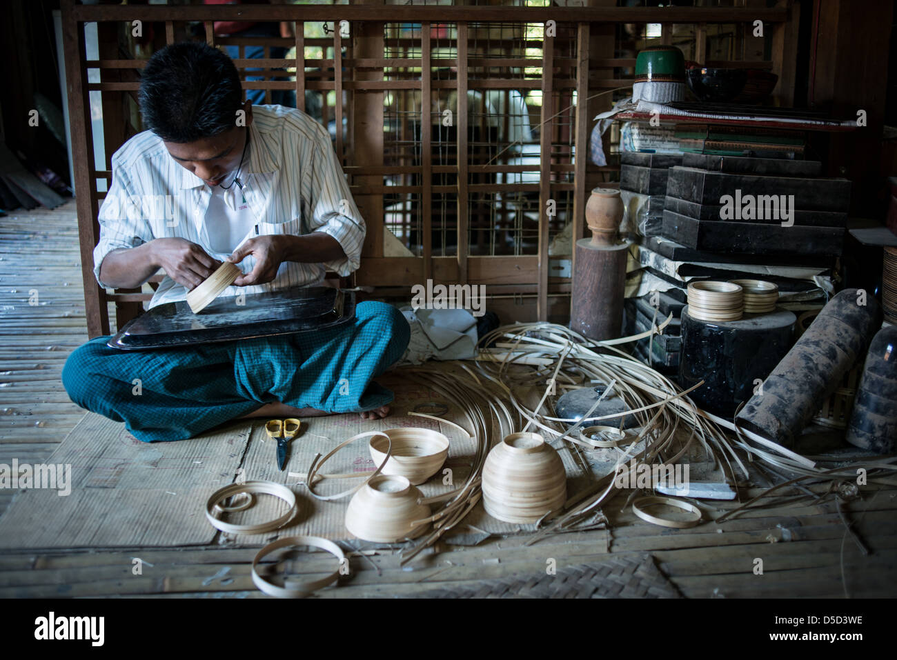 Man working on a bowl before adding the lacquer Stock Photo