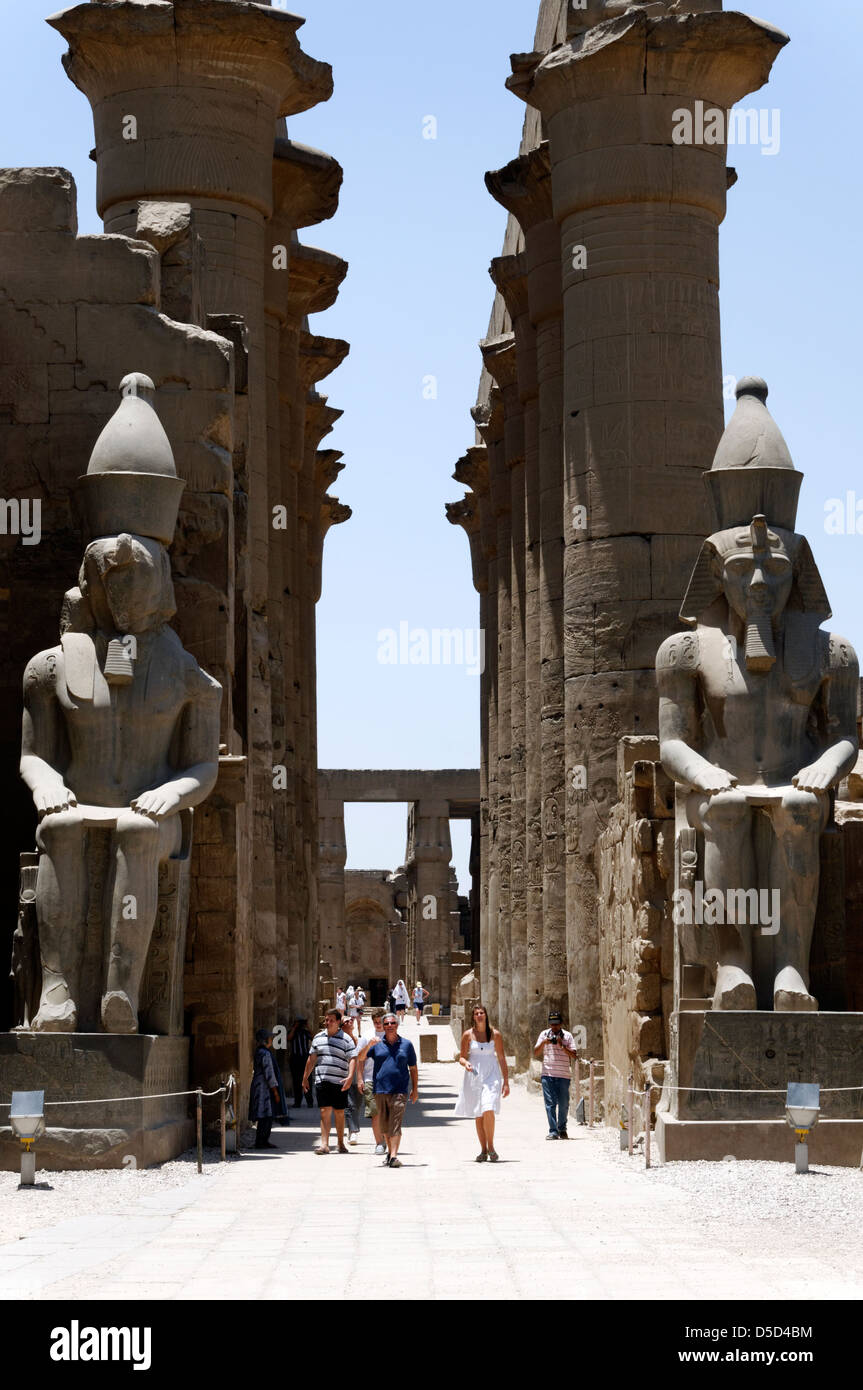 Egypt. Entrance to the Great Colonnade of Amenhotep III is flanked by two colossal statues of Rameses II at the Temple of Luxor. Stock Photo